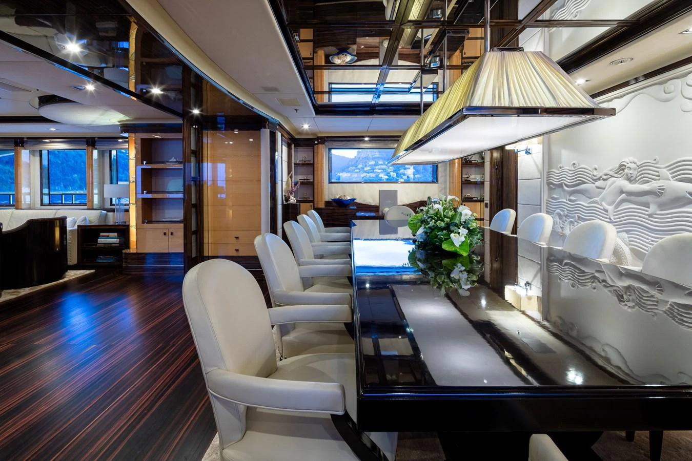 The yacht's dining area features a sleek table with plush seating and elegant decor. aboard VISION Yacht for Sale