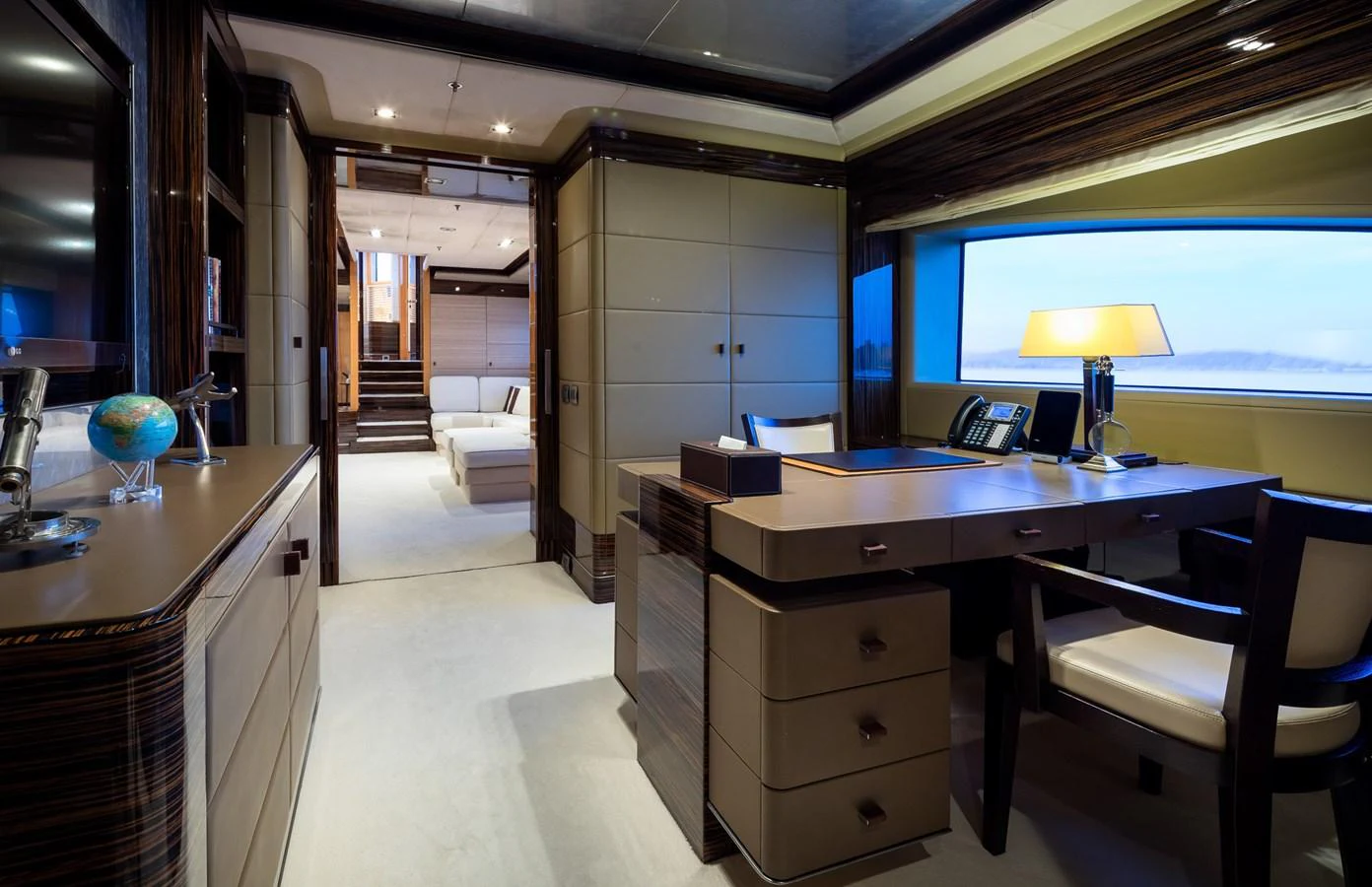 The yacht's office features a sophisticated workspace with elegant furnishings and ample natural light. aboard VISION Yacht for Sale