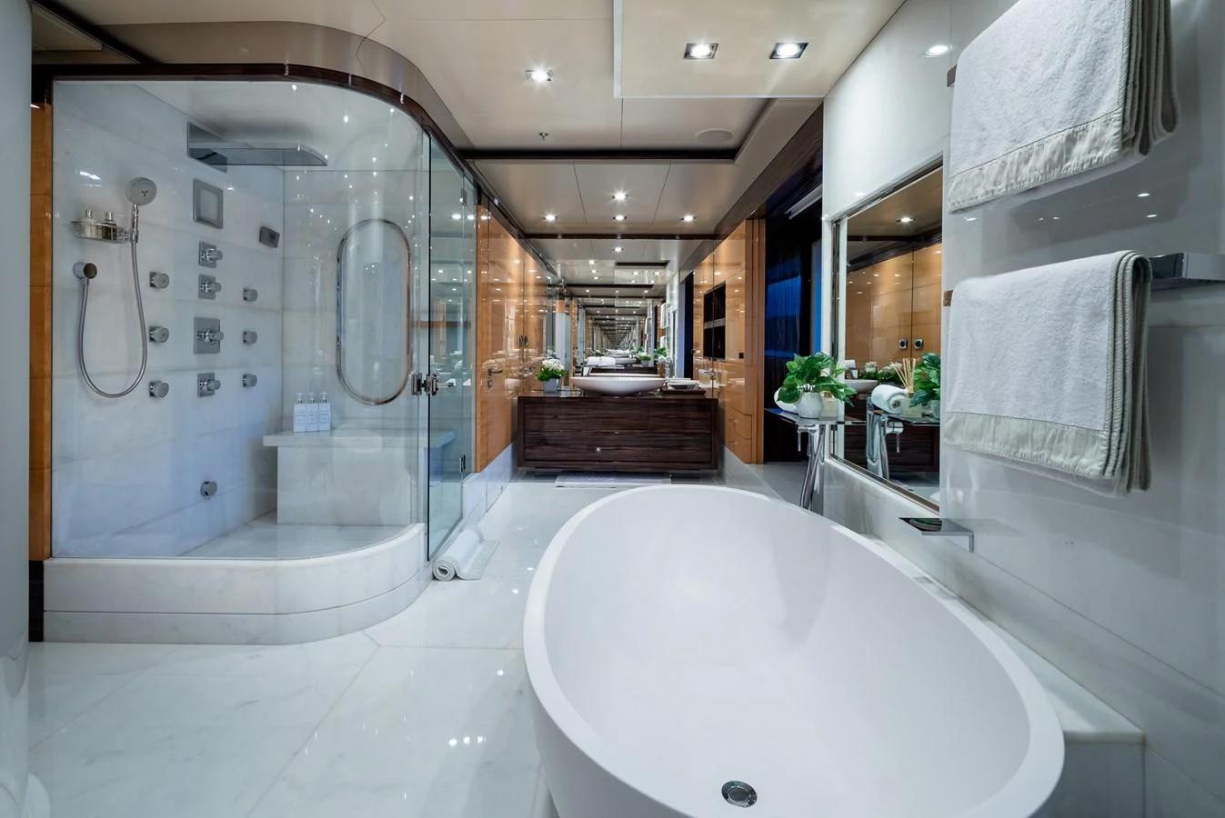The luxurious bathroom features a spacious bathtub, a glass-enclosed shower, and elegant fixtures. aboard VISION Yacht for Sale