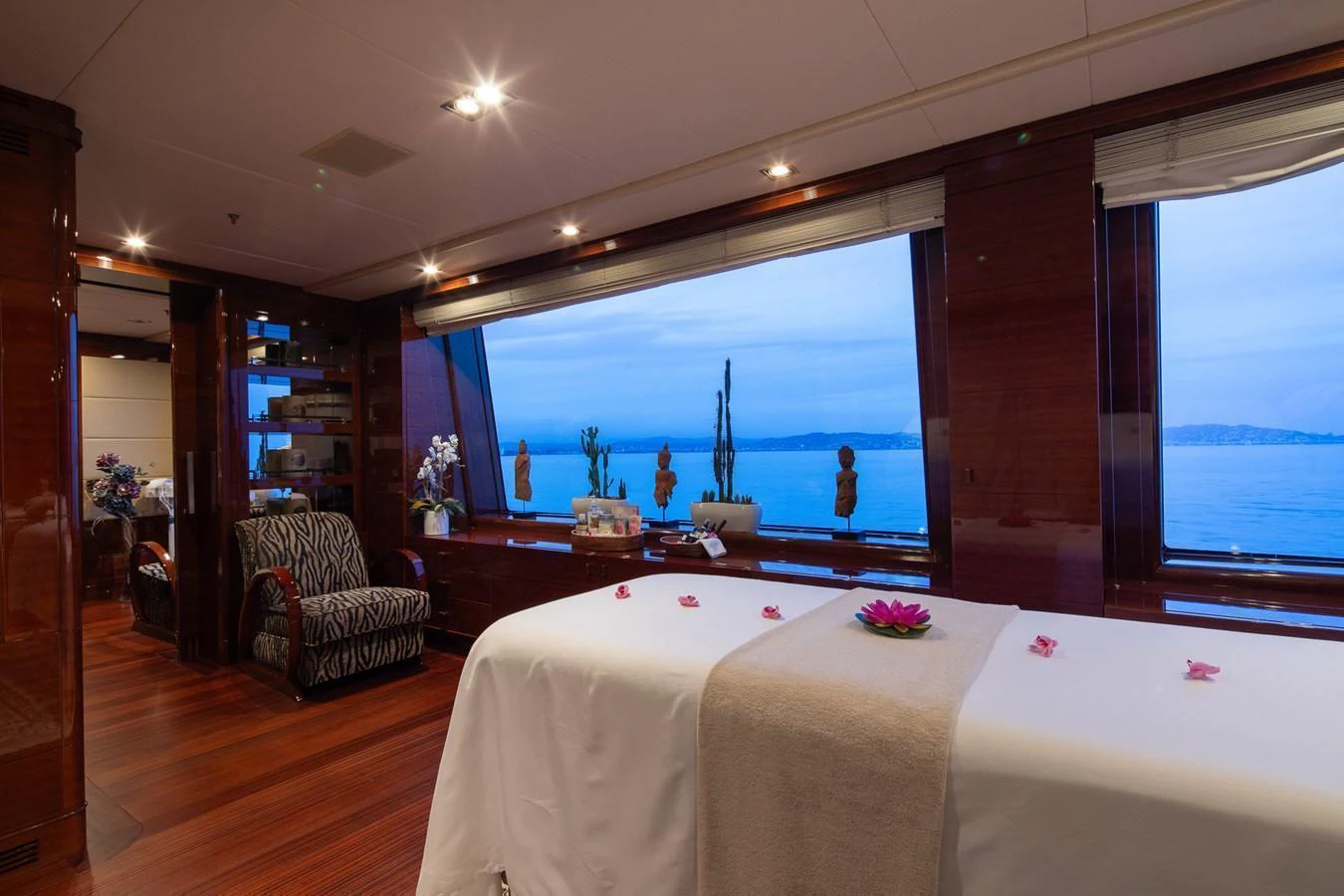 The yacht's spa room offers a serene space with a massage table and panoramic ocean views. aboard VISION Yacht for Sale