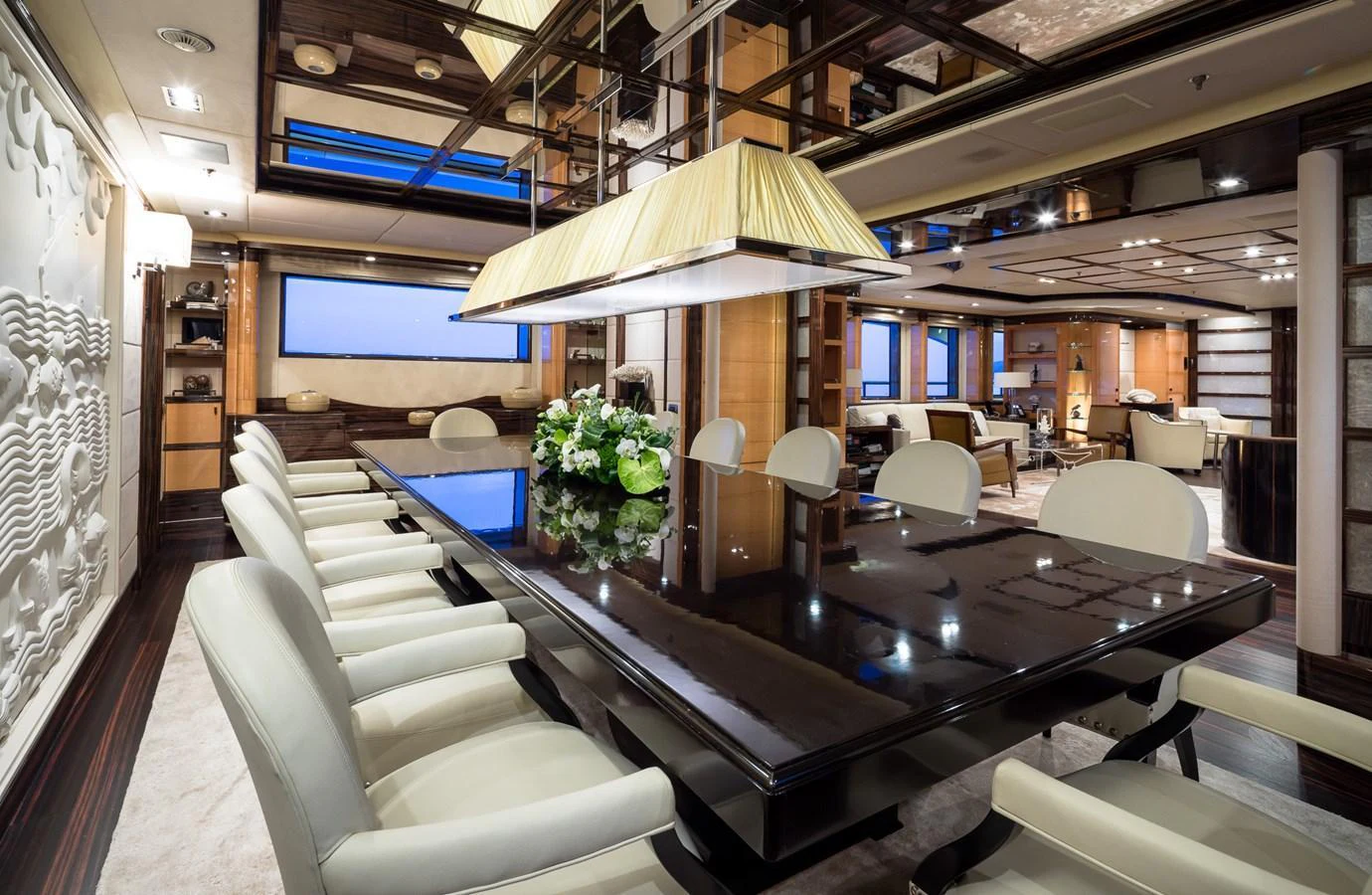 The yacht's dining area features a sleek, modern design with a large table and comfortable seating. aboard VISION Yacht for Sale