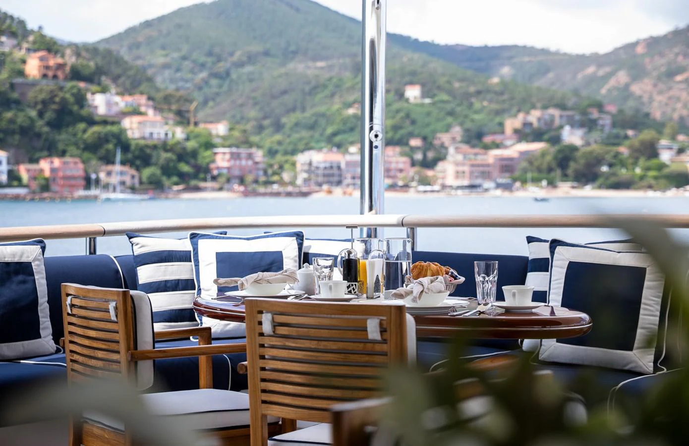 The aft deck offers a picturesque dining area with comfortable seating and stunning views. aboard VISION Yacht for Sale