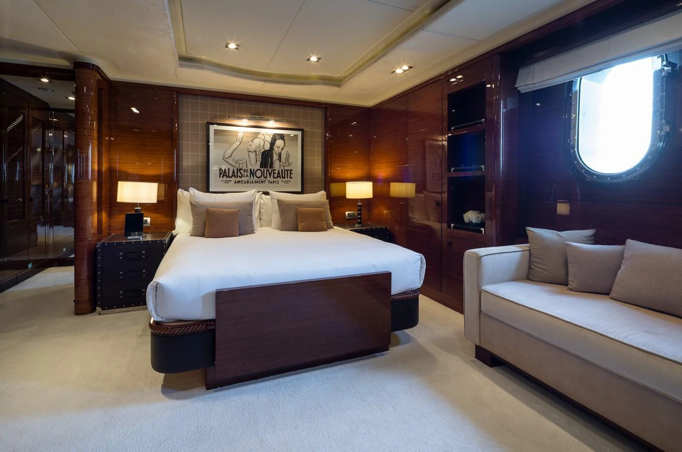 The master stateroom features a luxurious bed, elegant wood paneling, and ample natural light. aboard VISION Yacht for Sale