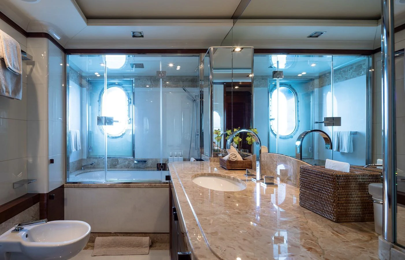 The yacht's bathroom features a luxurious marble countertop and spacious glass-enclosed shower. aboard VISION Yacht for Sale