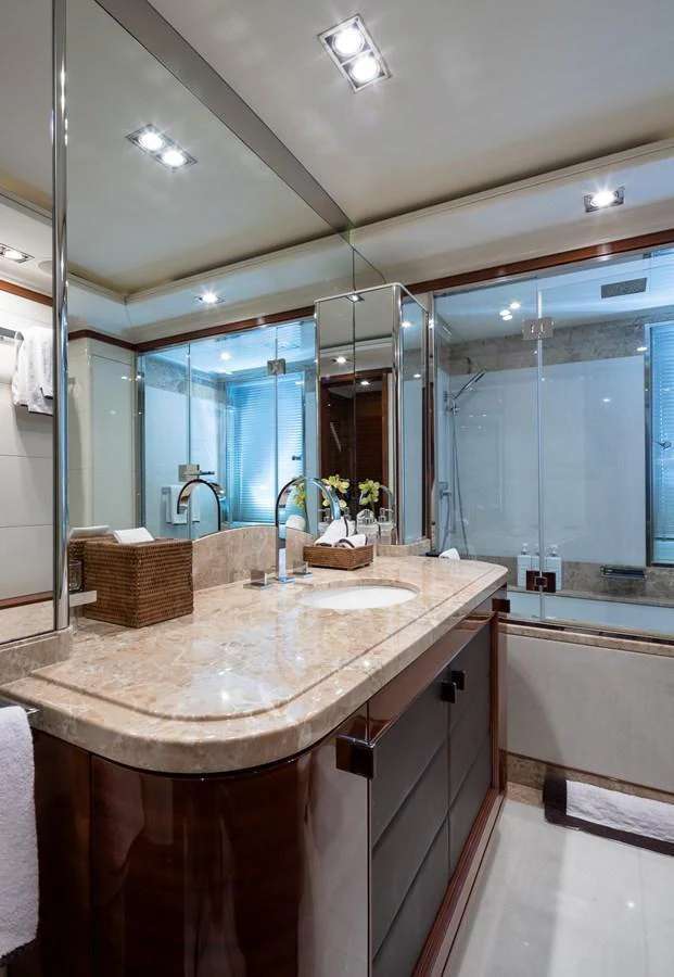 A luxurious yacht bathroom featuring a spacious vanity with dual sinks and elegant fixtures. aboard VISION Yacht for Sale
