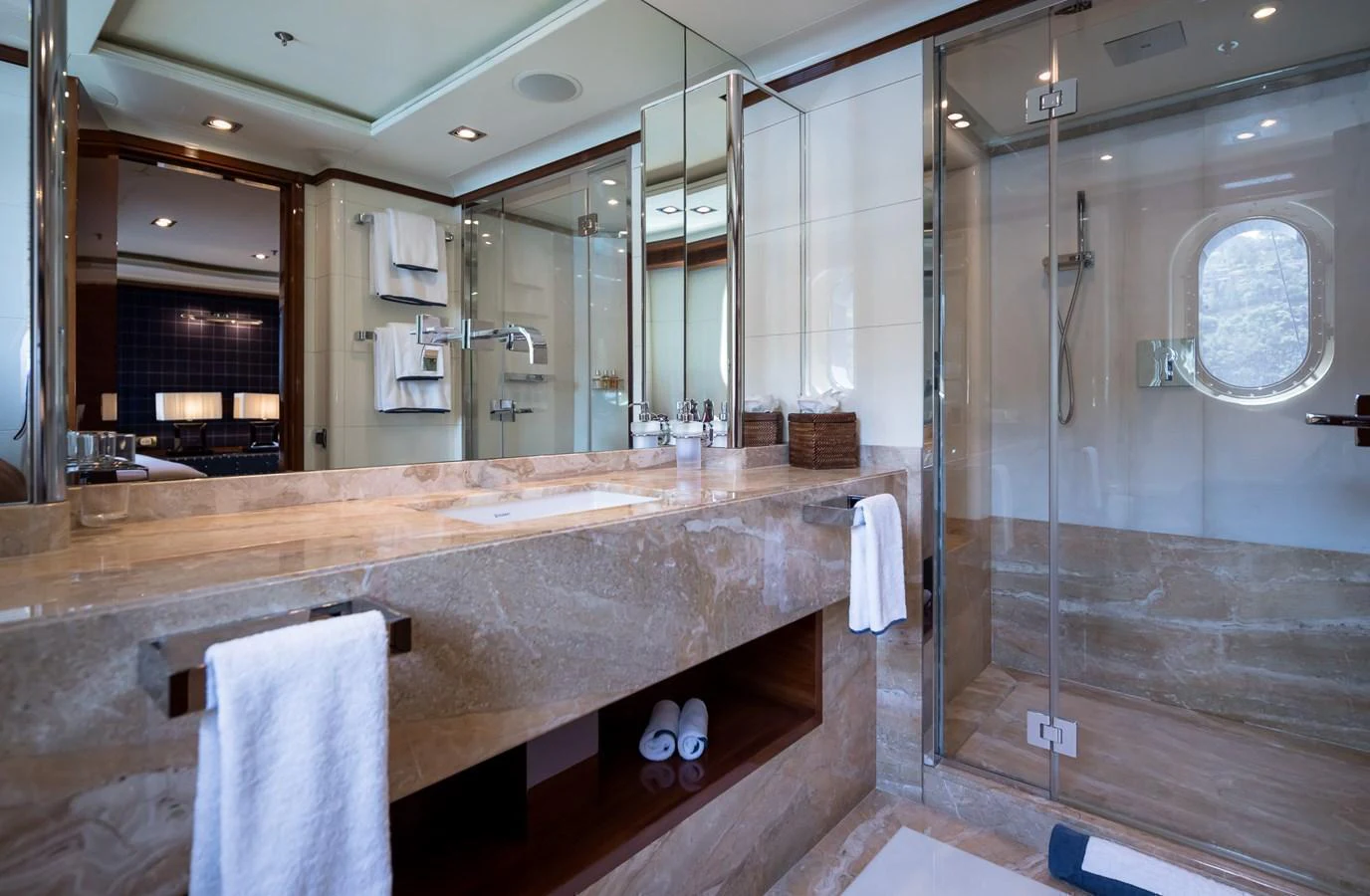 The yacht's bathroom features luxurious marble countertops and a spacious glass-enclosed shower. aboard VISION Yacht for Sale