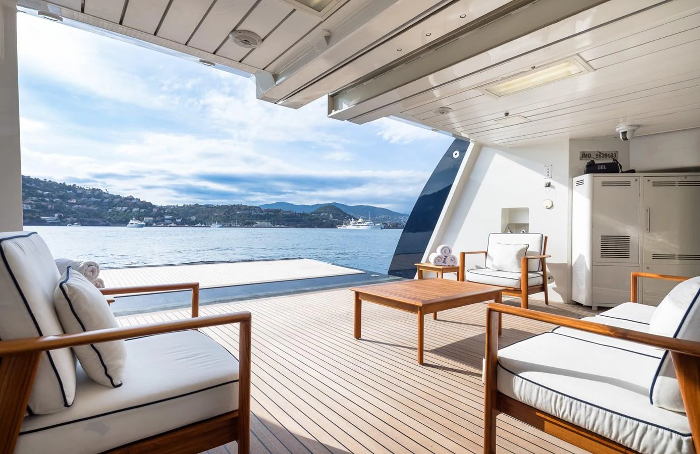 The aft deck offers a serene outdoor lounging area with comfortable seating and stunning views of the water. aboard VISION Yacht for Sale