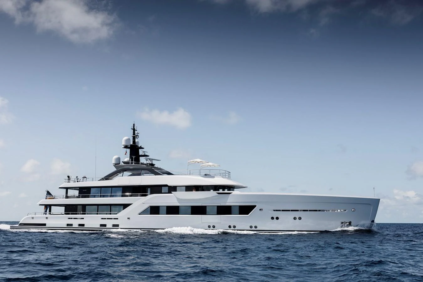 A sleek and modern yacht cruising on open waters under a clear sky. aboard AMELS 60 Yacht for Sale