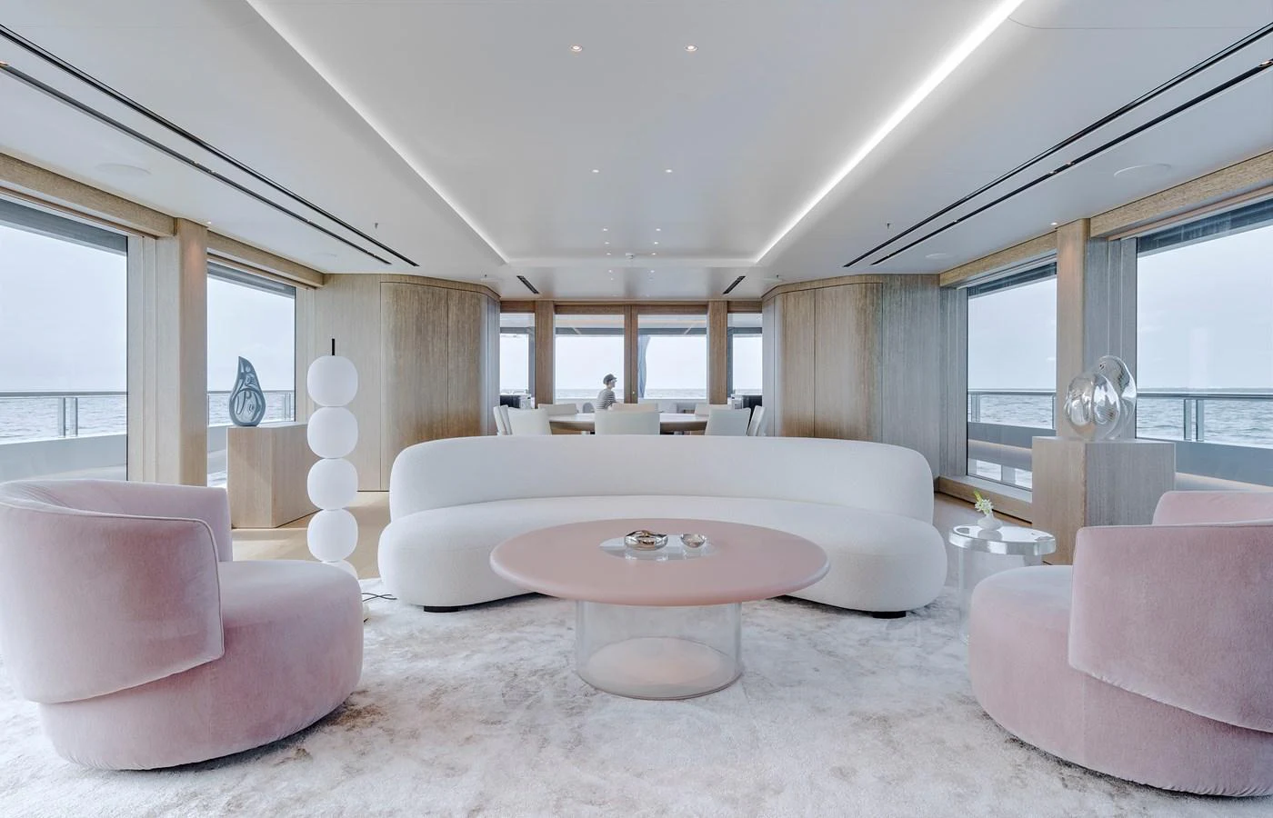 The salon features a modern and elegant design with plush seating and panoramic windows offering stunning sea views. aboard AMELS 60 Yacht for Sale