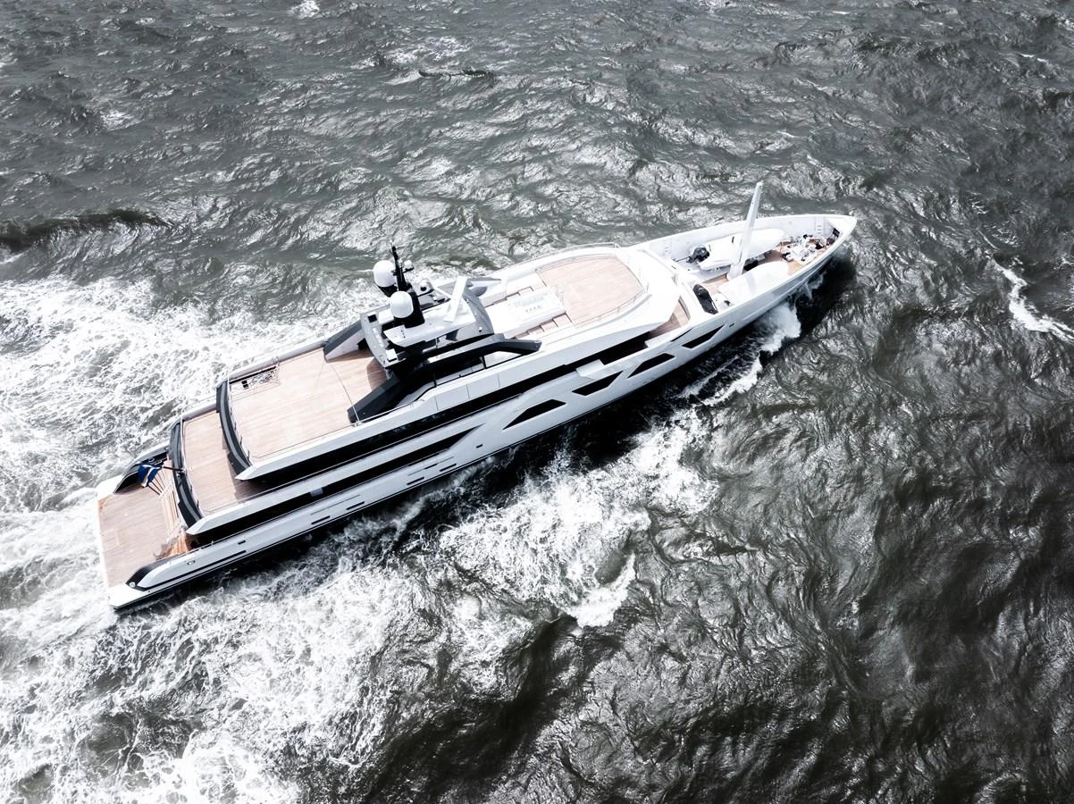 A sleek and modern yacht cruises through choppy waters, showcasing its elegant design and spacious deck areas. aboard AMELS 60 Yacht for Sale