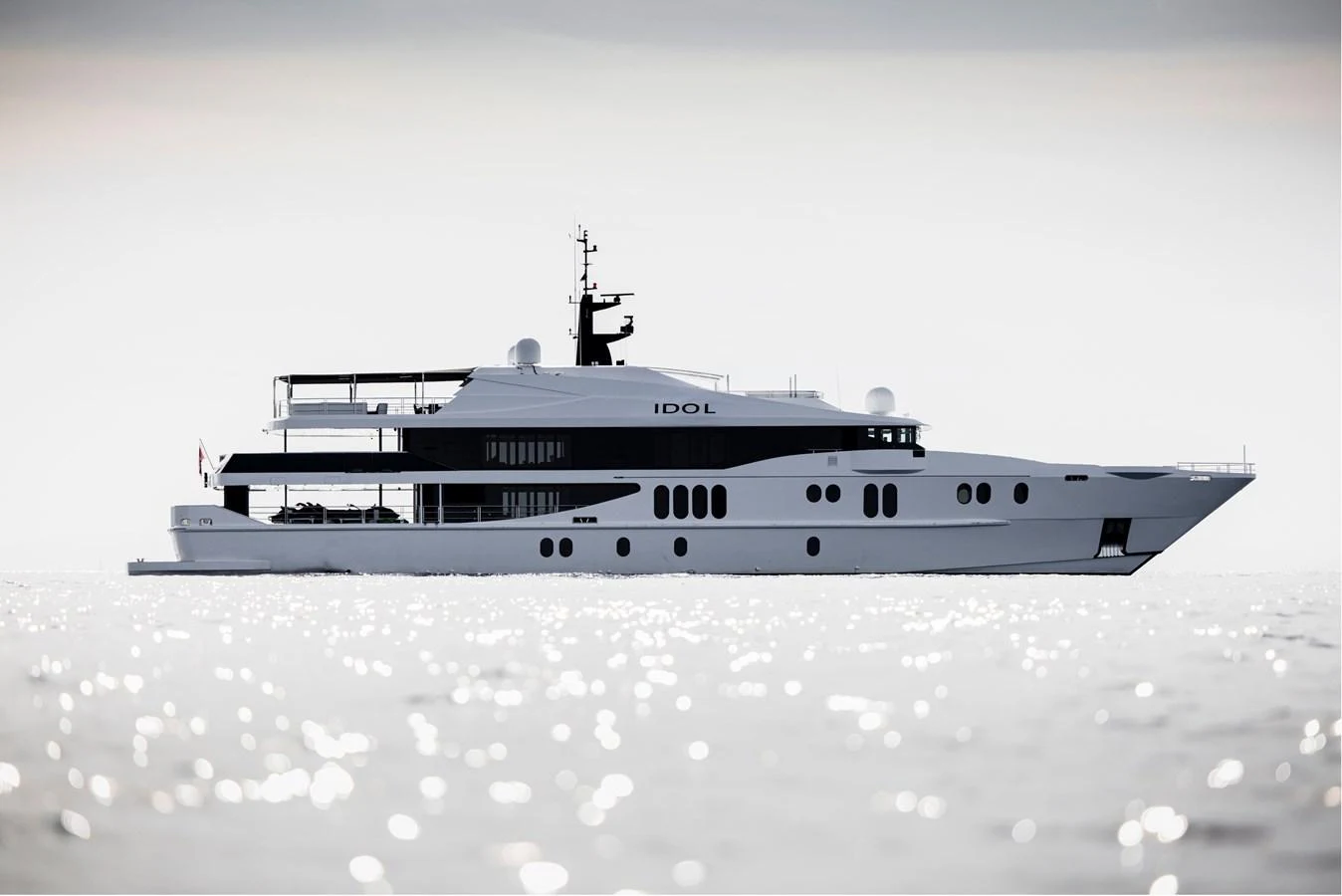 A sleek and modern yacht glides gracefully on calm waters, showcasing its elegant profile. aboard IDOL Yacht for Sale