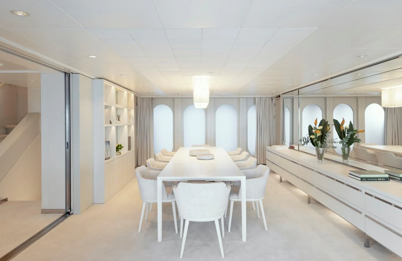 The yacht's dining area features a sleek, modern design with ample seating and elegant decor. aboard IDOL Yacht for Sale