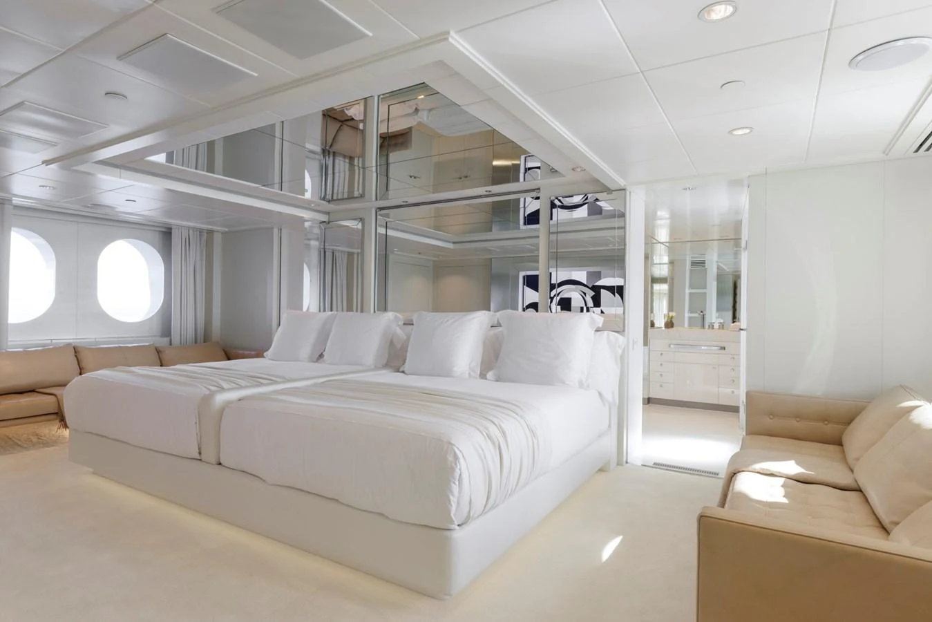 The master stateroom features a spacious bed, ample seating, and large windows for natural light. aboard IDOL Yacht for Sale