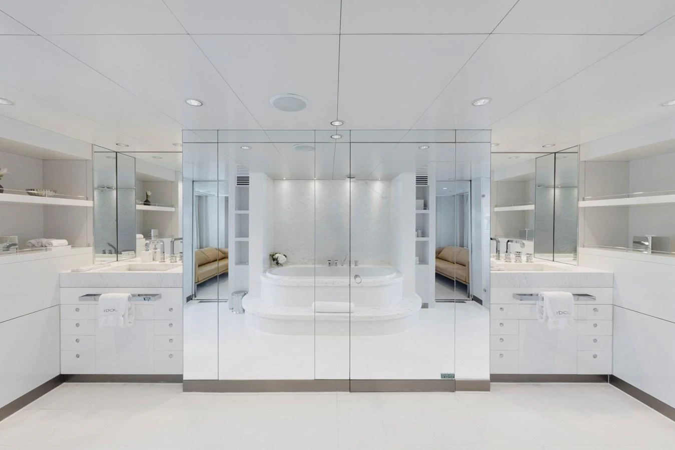 The yacht's bathroom features a luxurious and spacious design with a central bathtub and mirrored walls. aboard IDOL Yacht for Sale