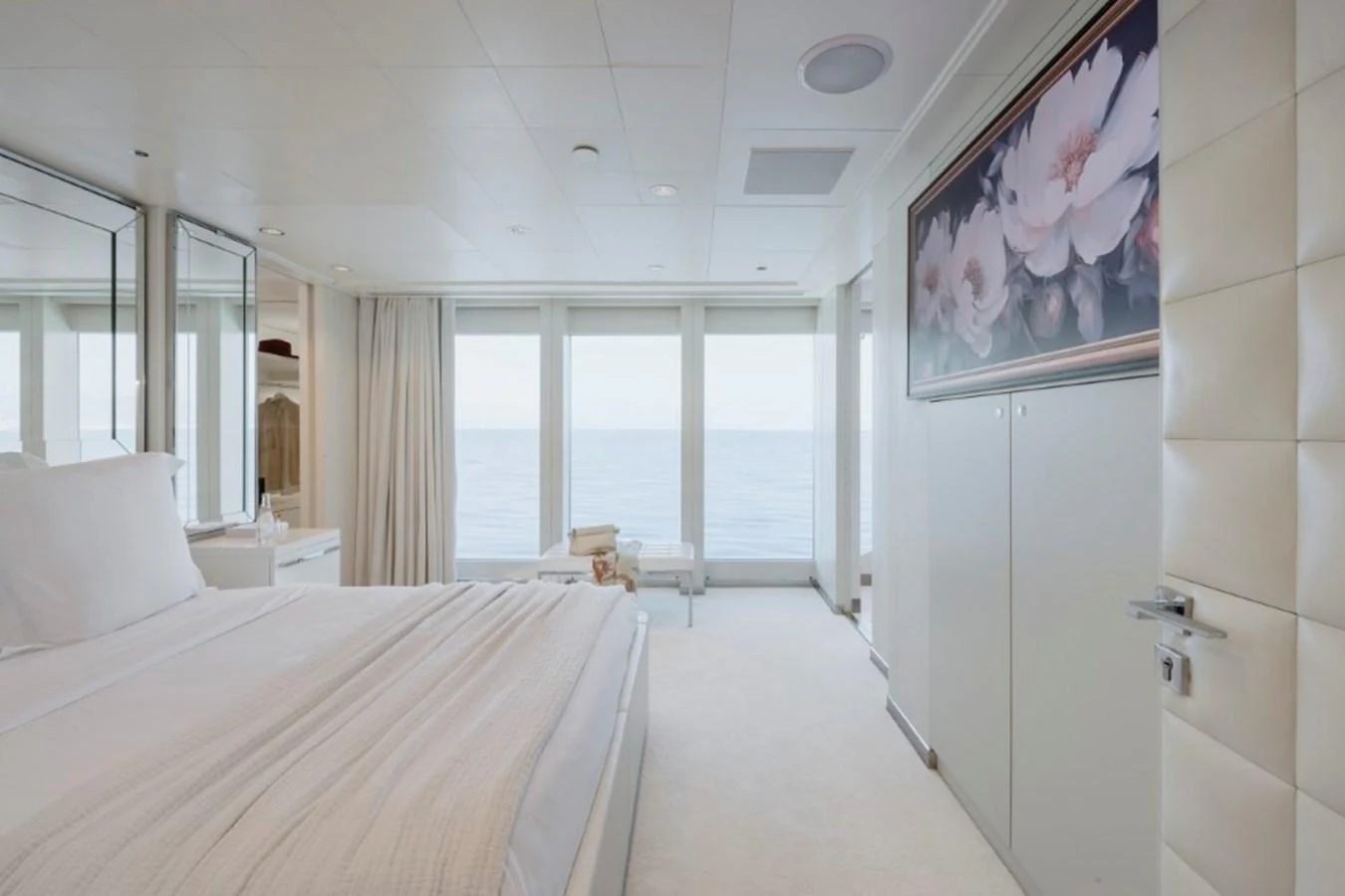 A serene stateroom with a large bed and panoramic ocean views. aboard IDOL Yacht for Sale