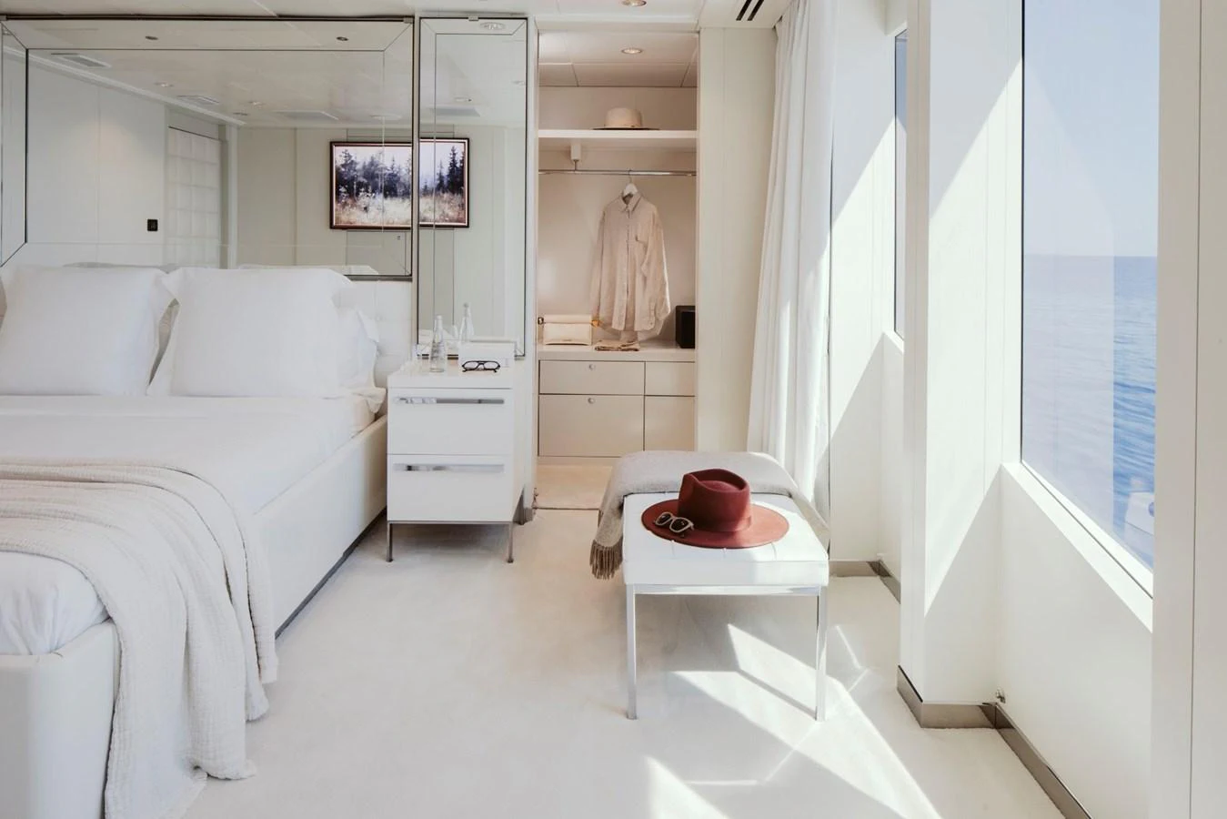 A serene stateroom with large windows offering a stunning ocean view. aboard IDOL Yacht for Sale