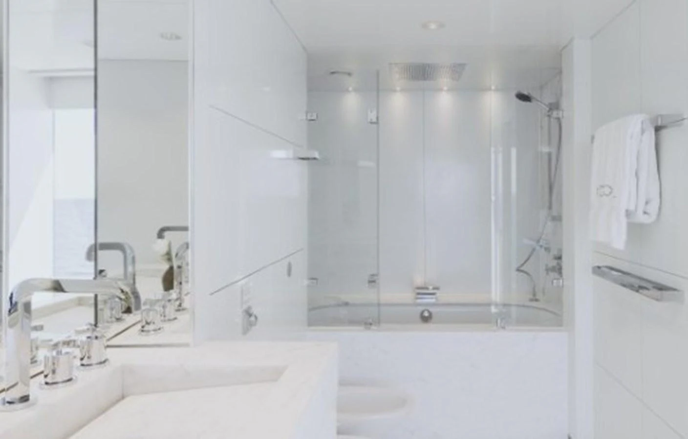 The yacht's bathroom features a sleek, modern design with a spacious shower and elegant fixtures. aboard IDOL Yacht for Sale