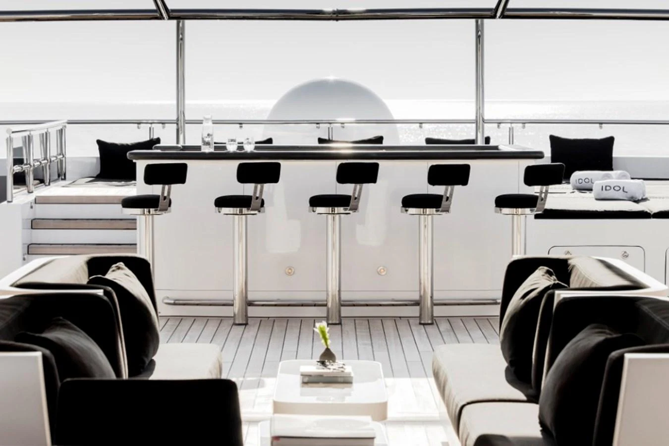 The yacht features a stylish bar area with modern seating and a sleek design. aboard IDOL Yacht for Sale