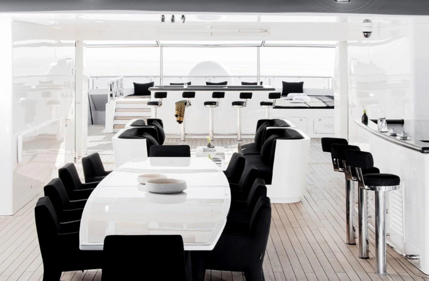 The yacht's dining area features a sleek, modern design with a spacious table and comfortable seating. aboard IDOL Yacht for Sale