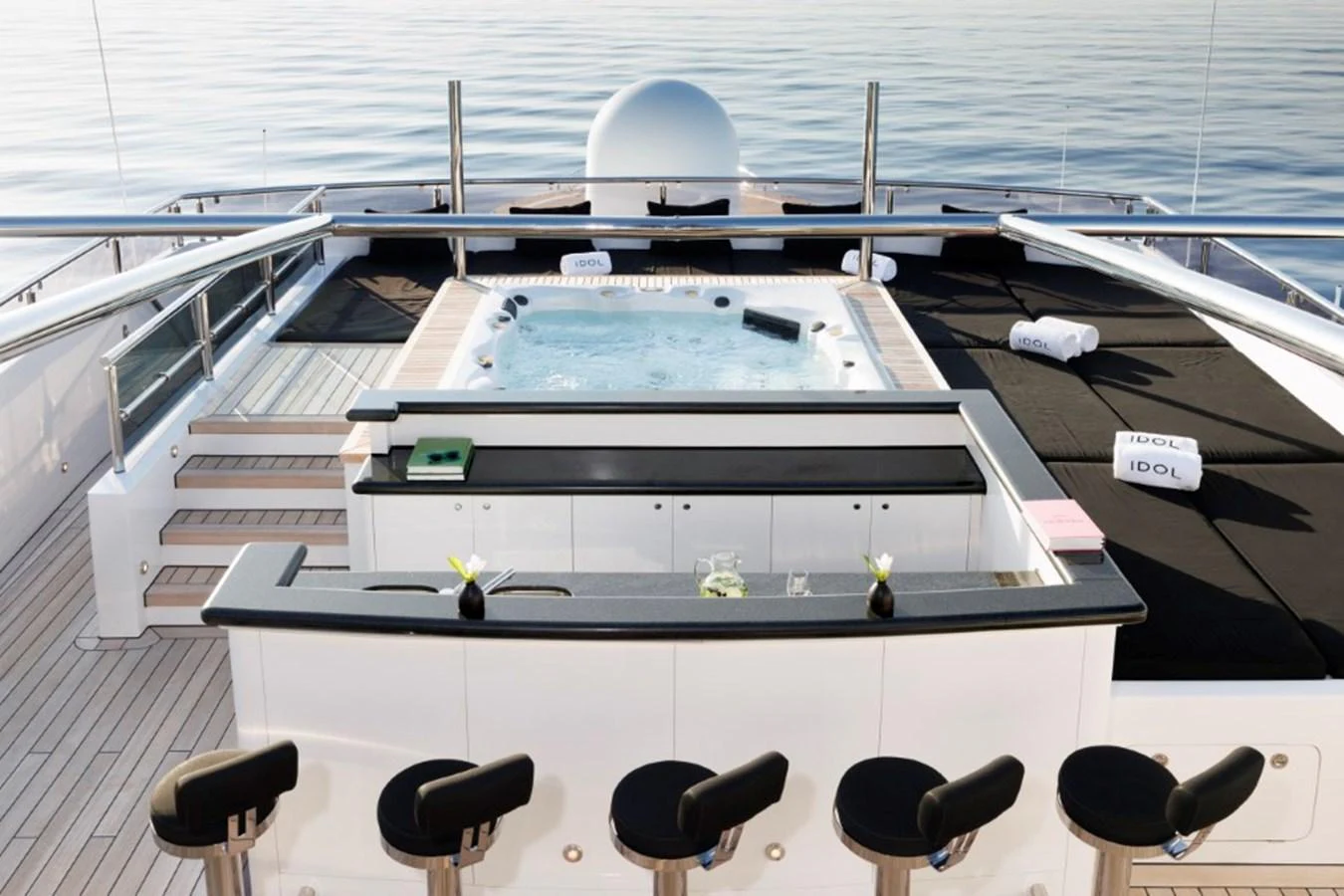 The sundeck features a luxurious jacuzzi and a stylish bar area with seating, perfect for relaxation and entertainment. aboard IDOL Yacht for Sale