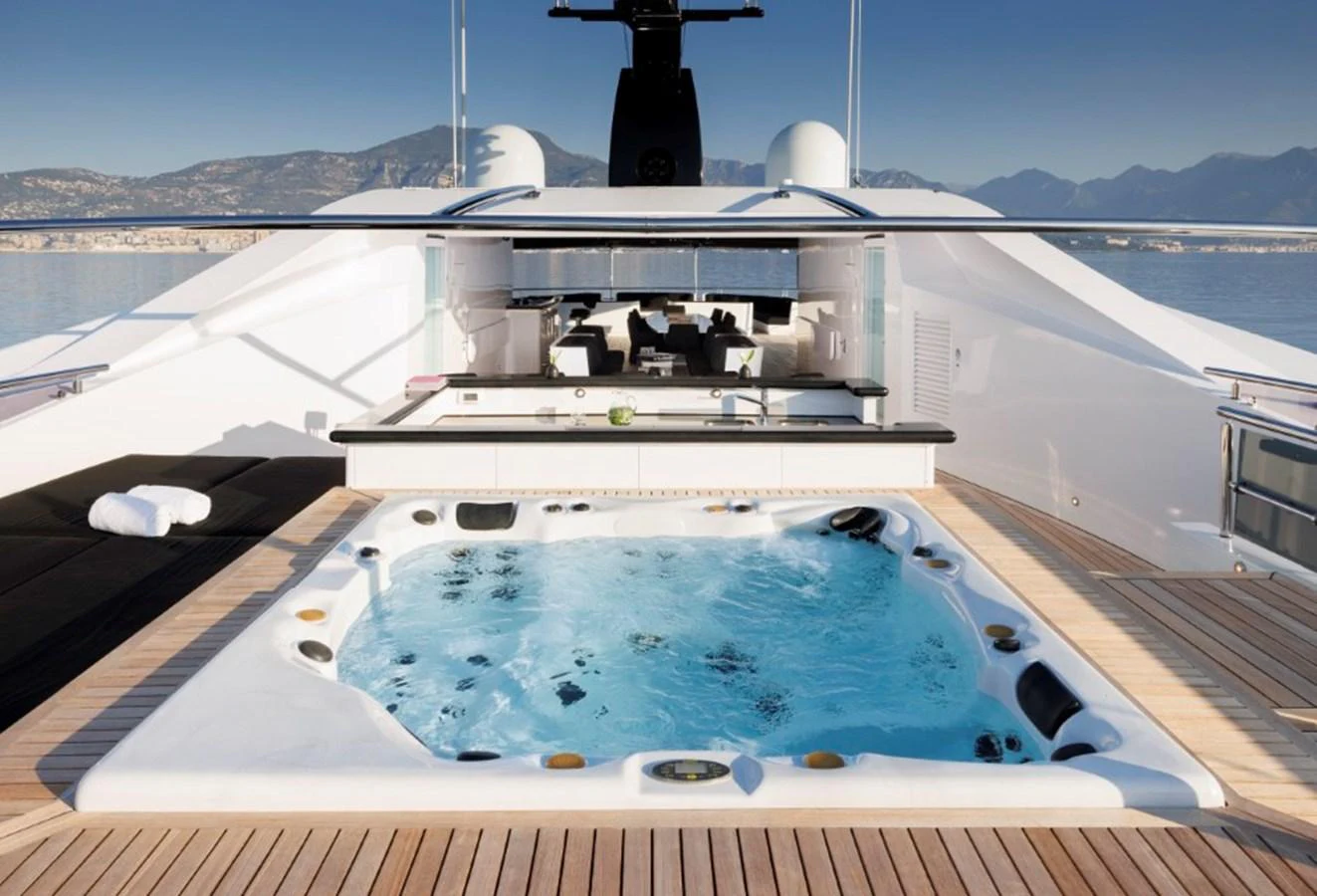 The sundeck features a luxurious hot tub with stunning views of the surrounding landscape. aboard IDOL Yacht for Sale