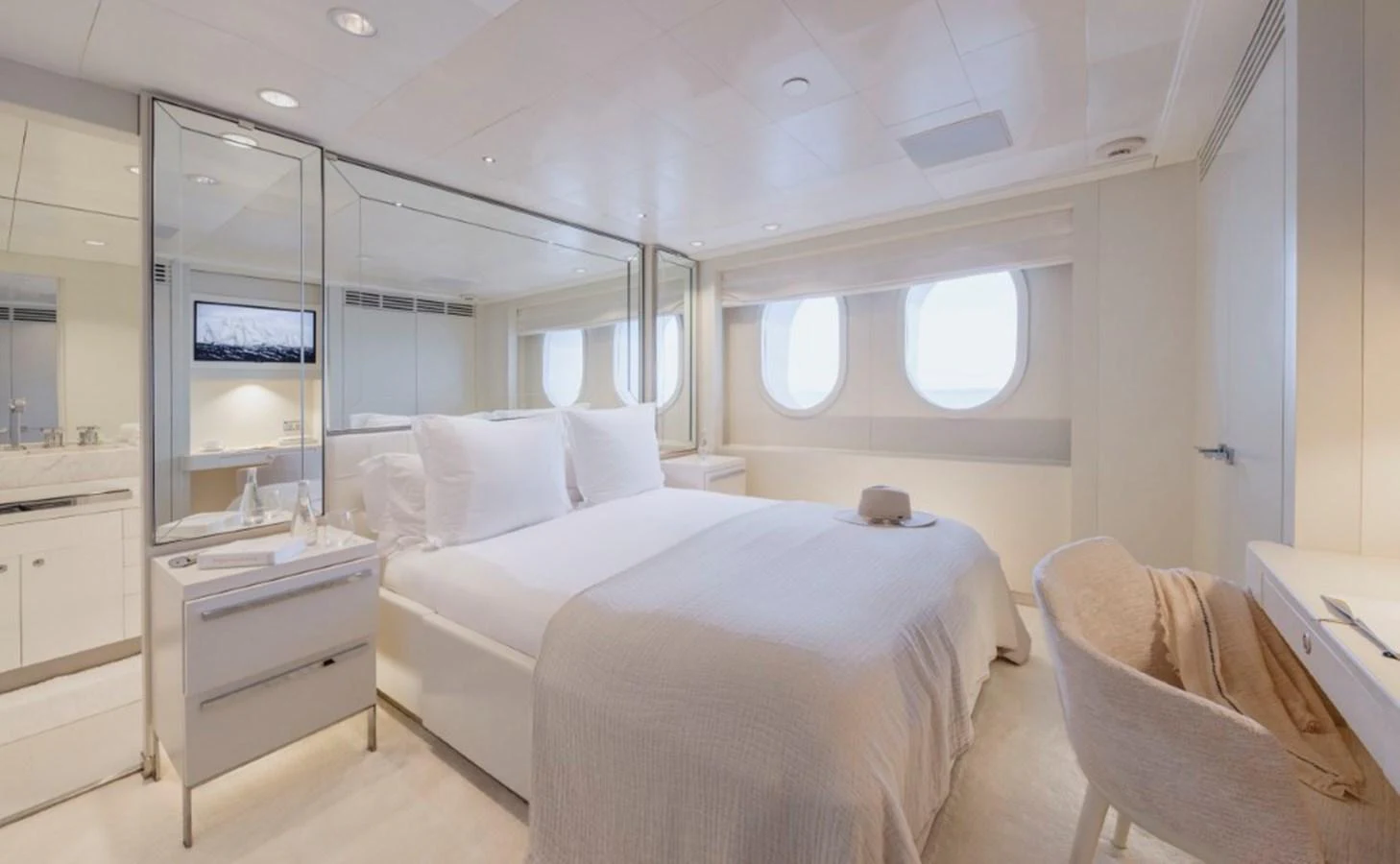 The stateroom features a luxurious bed with elegant bedding, complemented by large windows and a serene ambiance. aboard IDOL Yacht for Sale