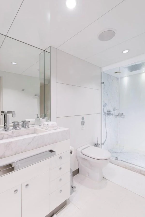 A pristine yacht bathroom with modern fixtures and a glass-enclosed shower. aboard IDOL Yacht for Sale