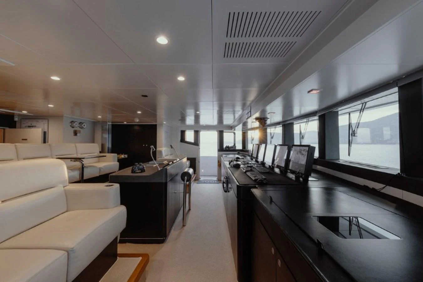 The helm station features a sleek, modern design with multiple screens and comfortable seating. aboard IDOL Yacht for Sale