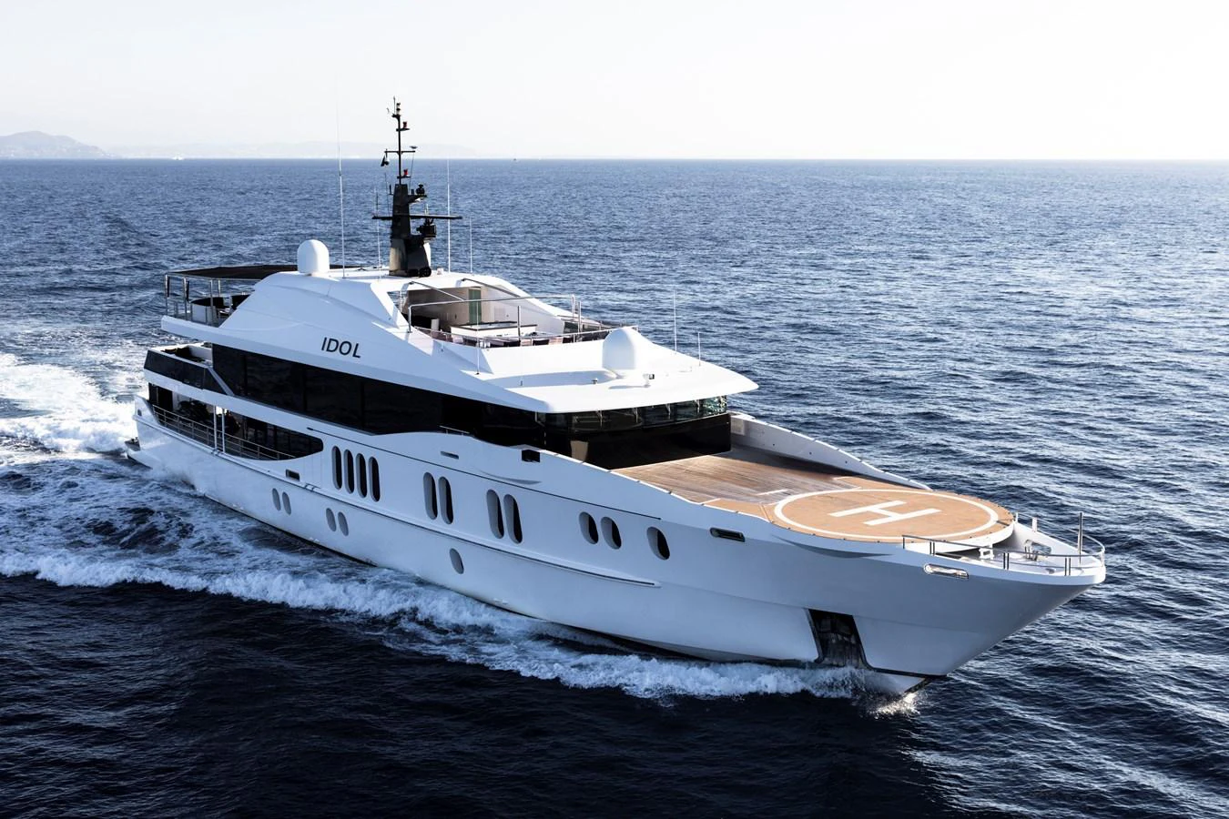 A sleek and modern yacht cruises through the open sea, showcasing its elegant design and spacious deck. aboard IDOL Yacht for Sale