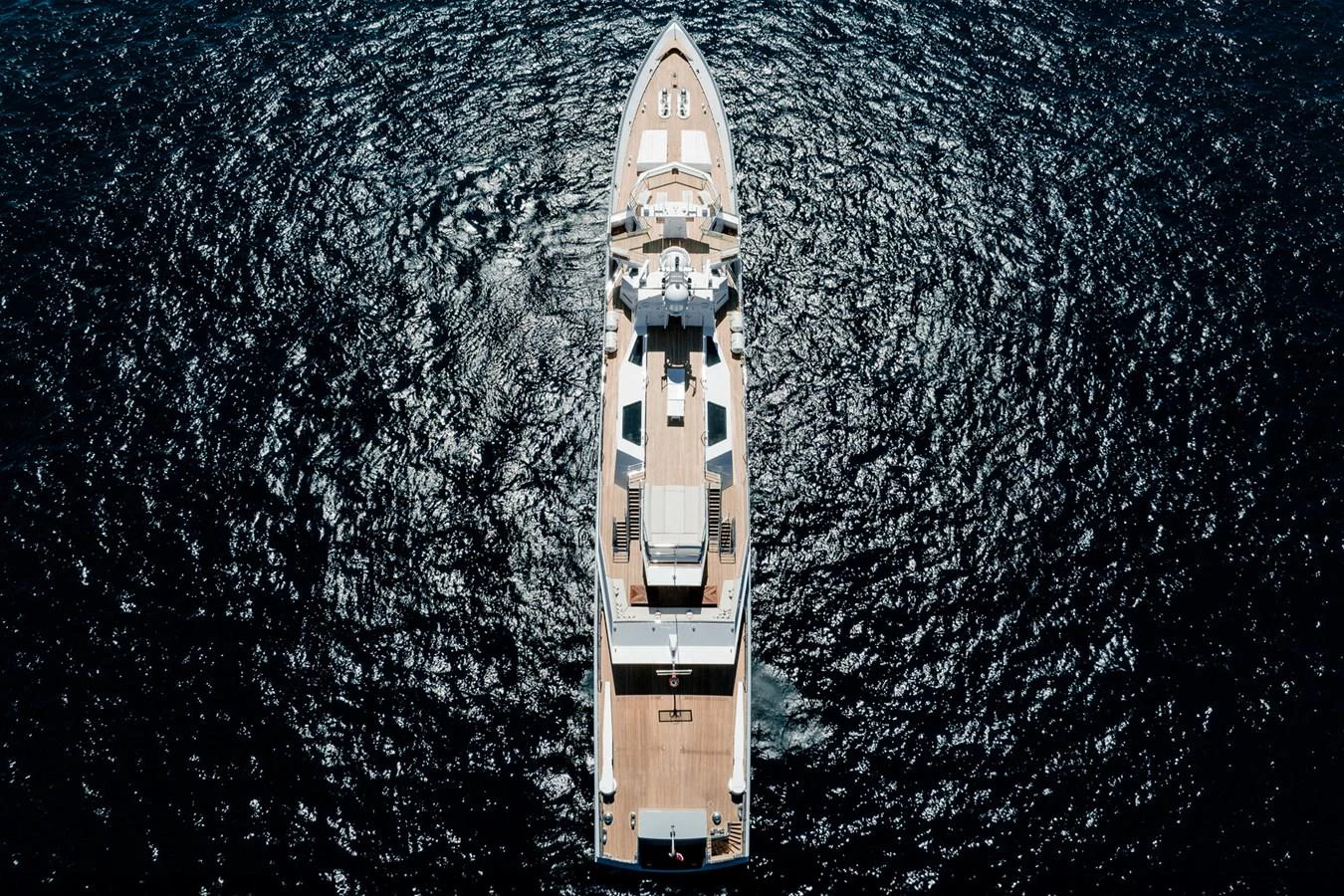 An aerial view of a luxurious yacht cruising through deep blue waters. aboard RONIN Yacht for Sale
