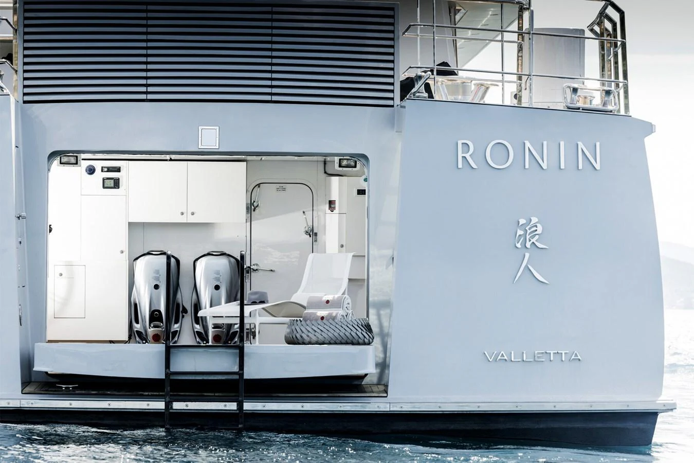 The yacht features a sleek and modern stern with a garage for water toys and equipment. aboard RONIN Yacht for Sale