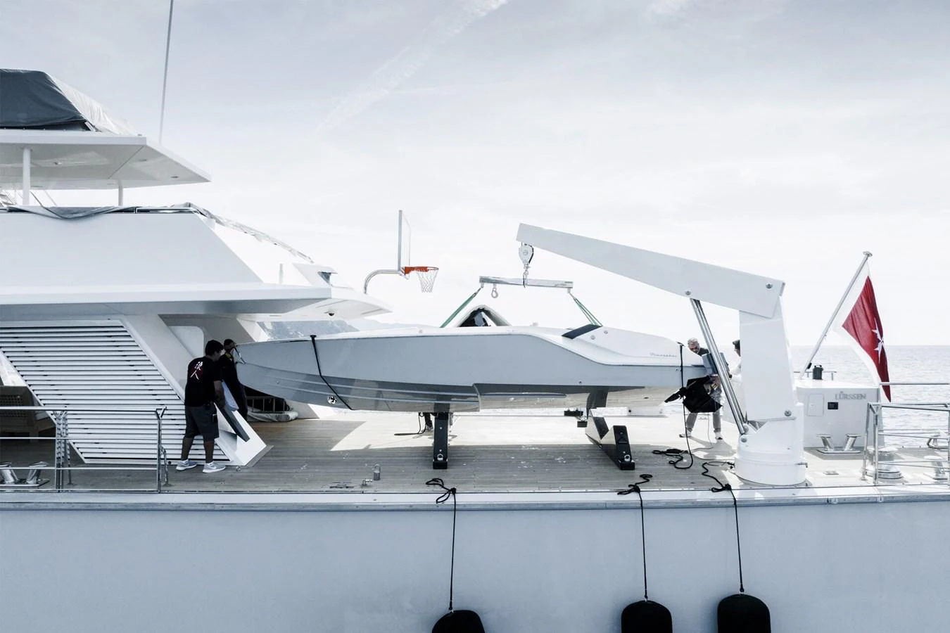 A sleek tender is being hoisted onto the deck of a luxurious yacht. aboard RONIN Yacht for Sale
