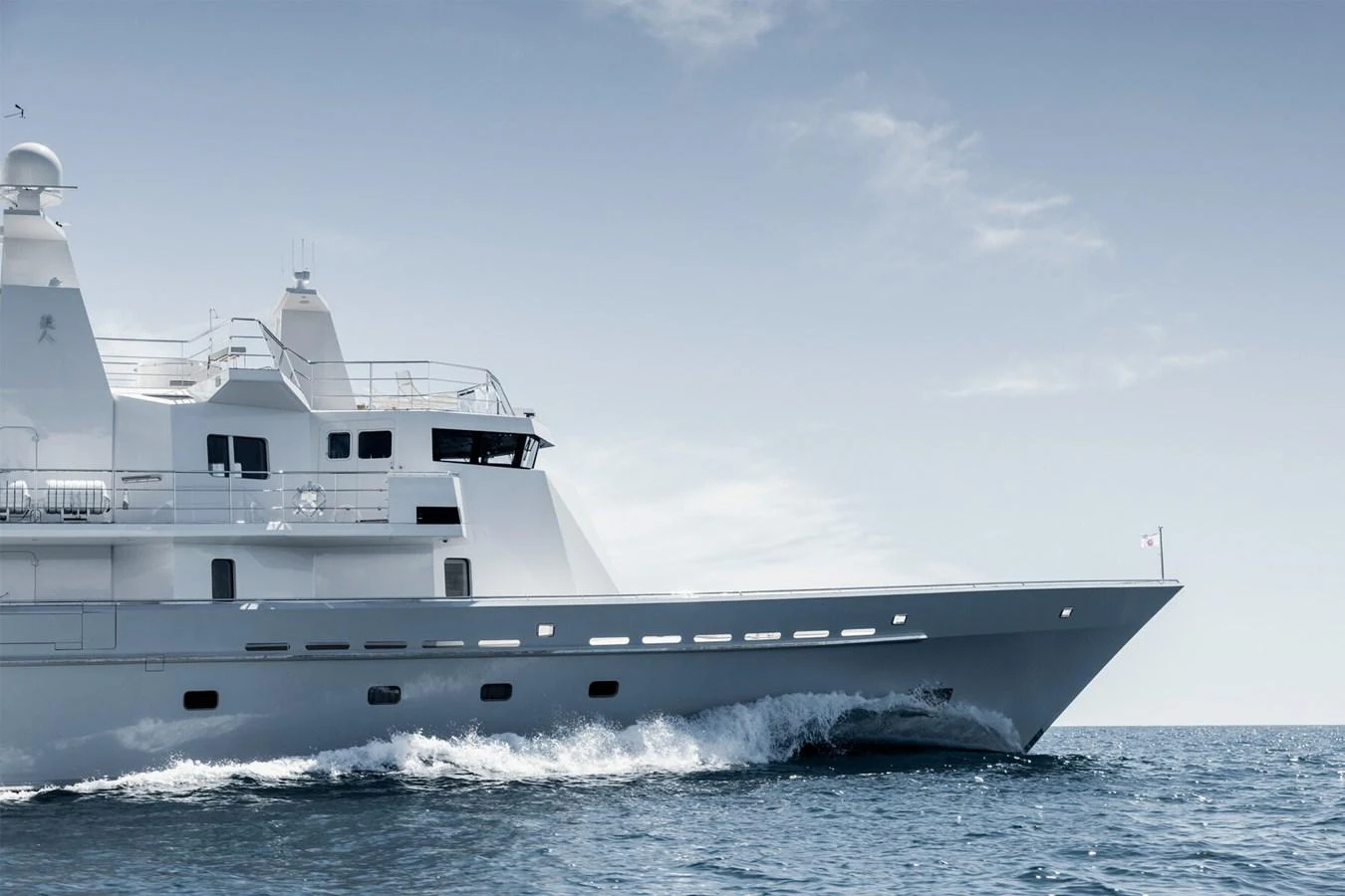A sleek and modern yacht cruises through the open sea, showcasing its impressive design and structure. aboard RONIN Yacht for Sale