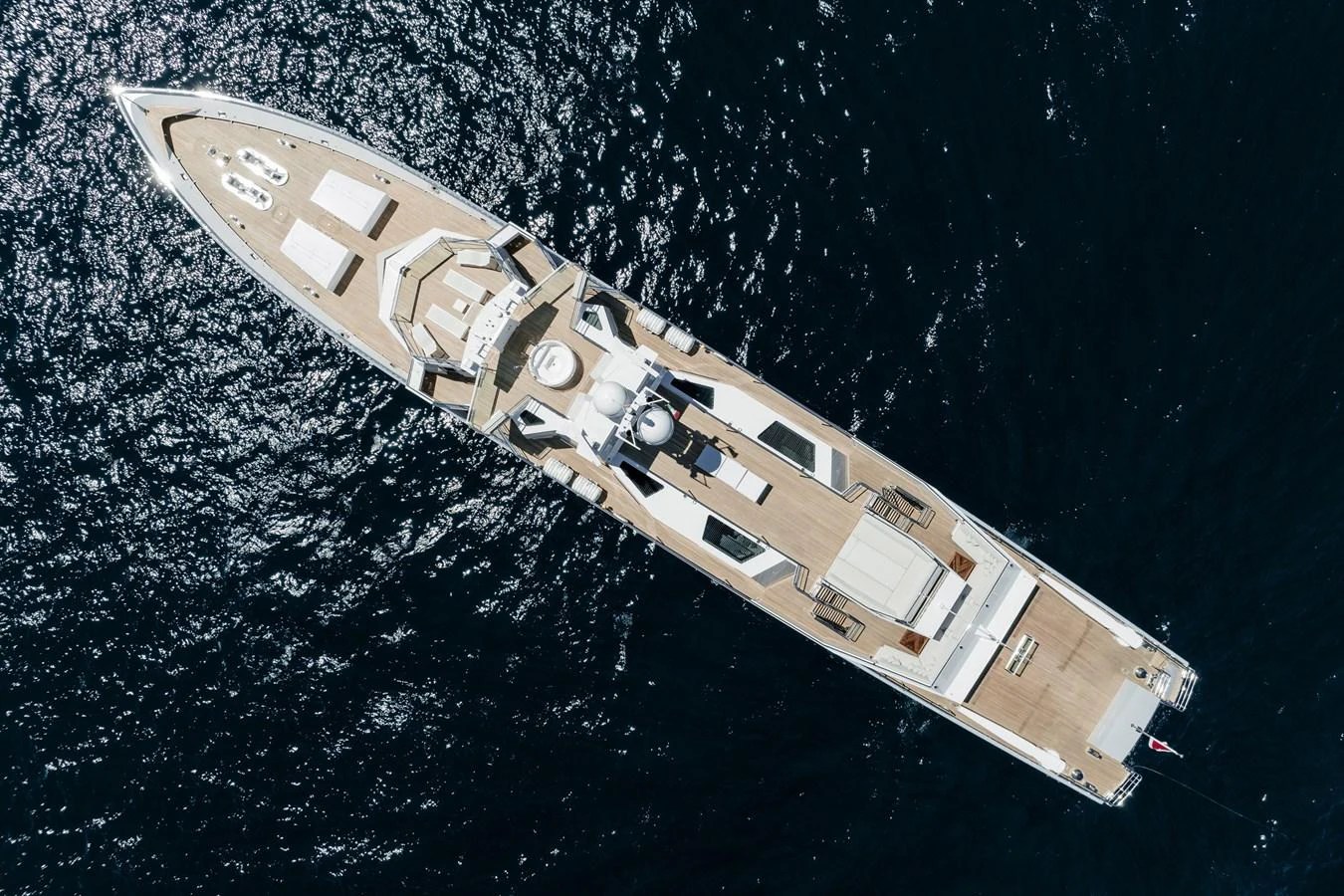 A stunning aerial view of a luxurious yacht cruising on the open sea. aboard RONIN Yacht for Sale