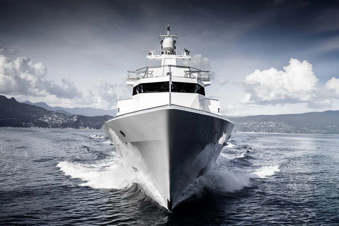 A sleek yacht cuts through the water, showcasing its impressive bow and modern design. aboard RONIN Yacht for Sale