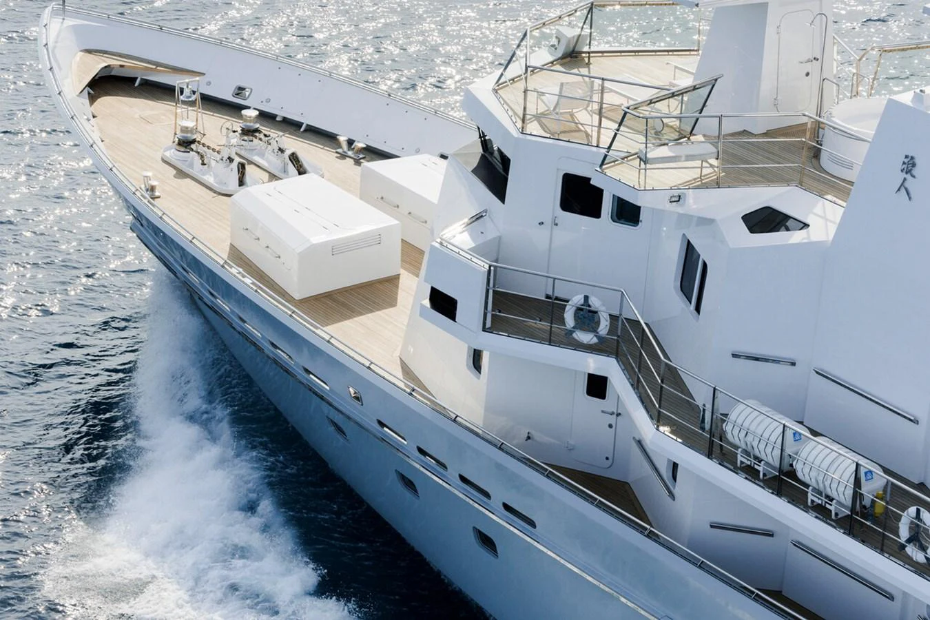 A sleek yacht glides through the water, showcasing its modern design and spacious deck. aboard RONIN Yacht for Sale