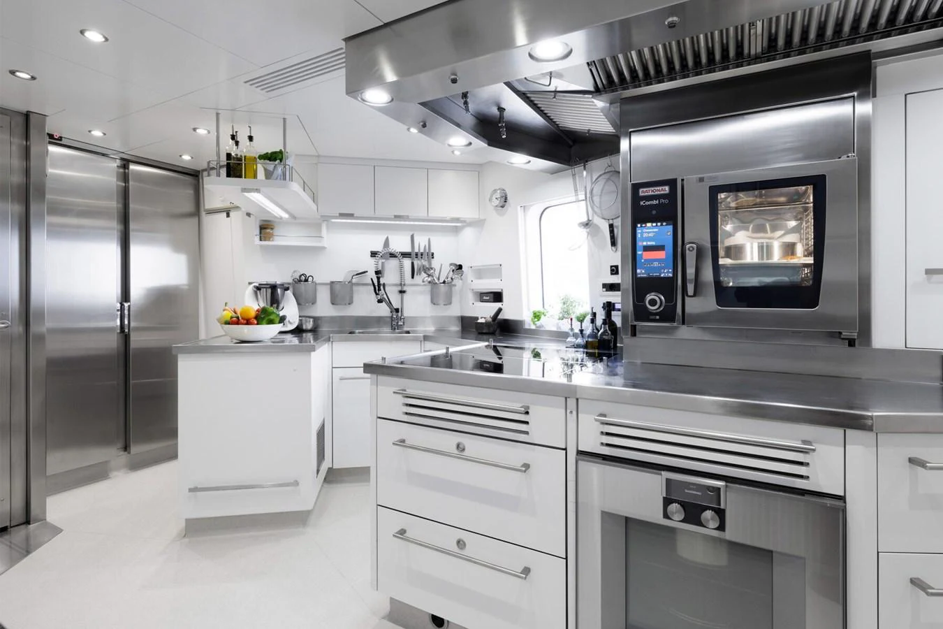 The yacht's galley is equipped with modern stainless steel appliances and sleek white cabinetry. aboard RONIN Yacht for Sale