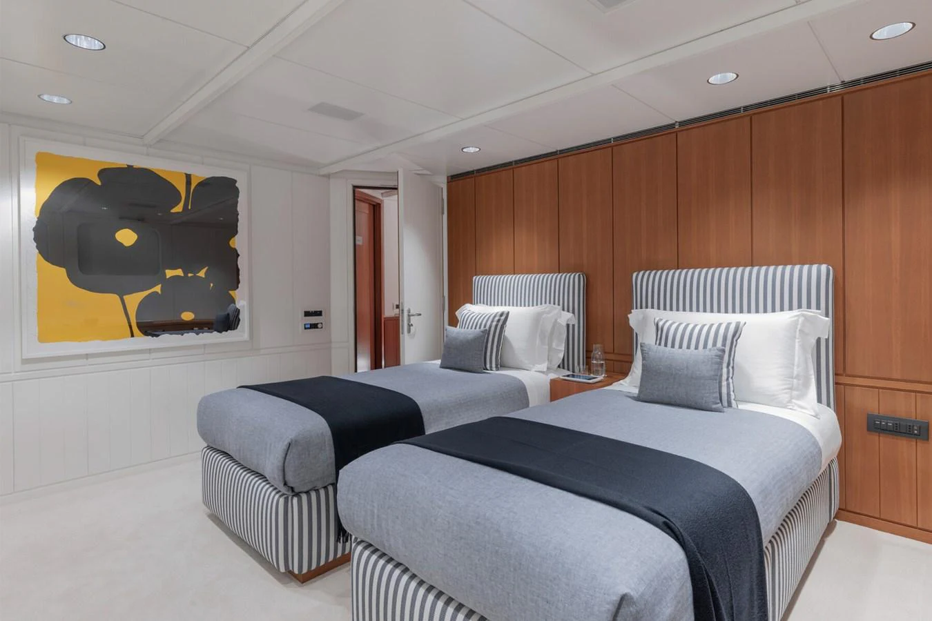 The guest stateroom features twin beds with a modern, stylish design. aboard RONIN Yacht for Sale