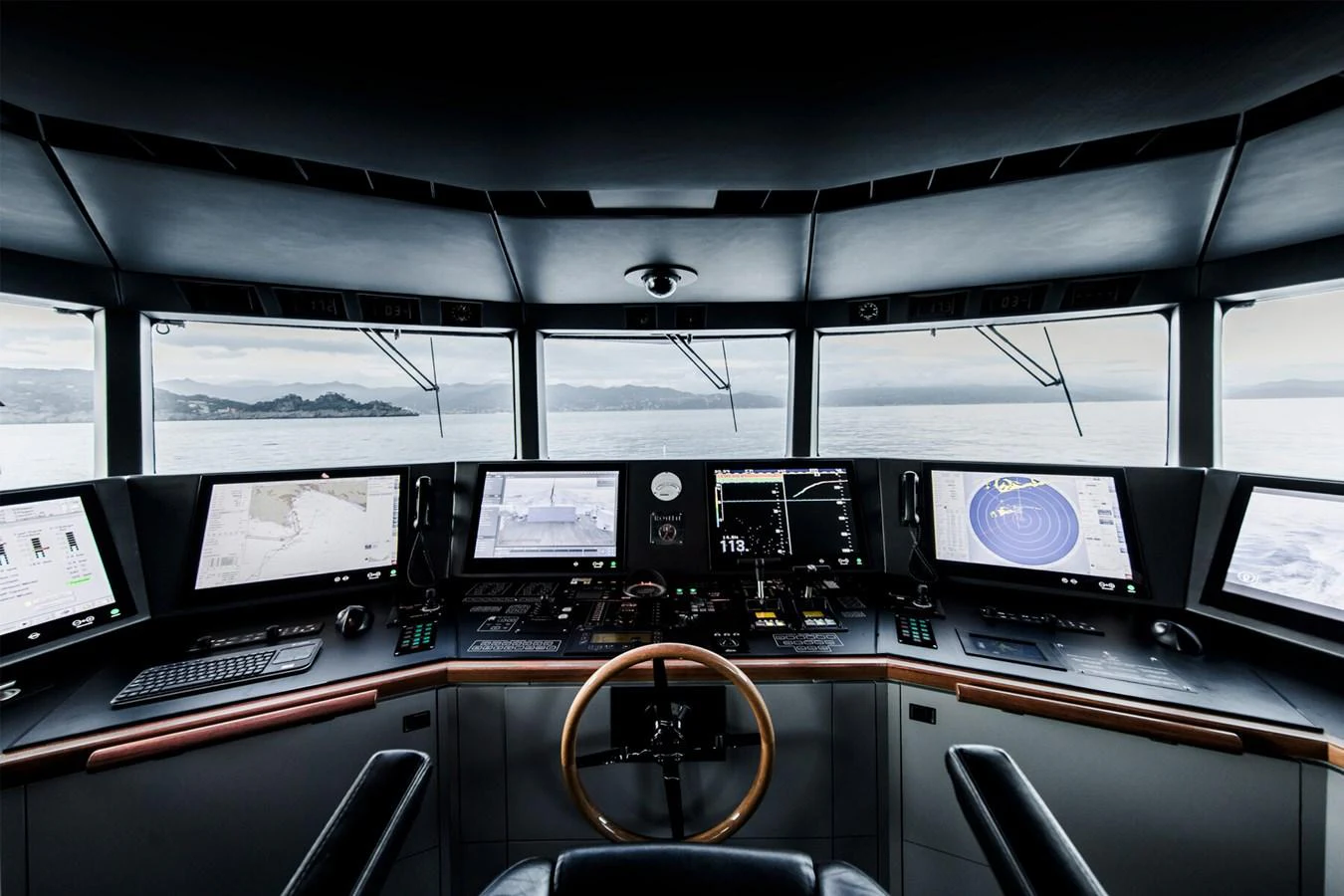 The helm station offers a commanding view with advanced navigation systems and multiple screens. aboard RONIN Yacht for Sale