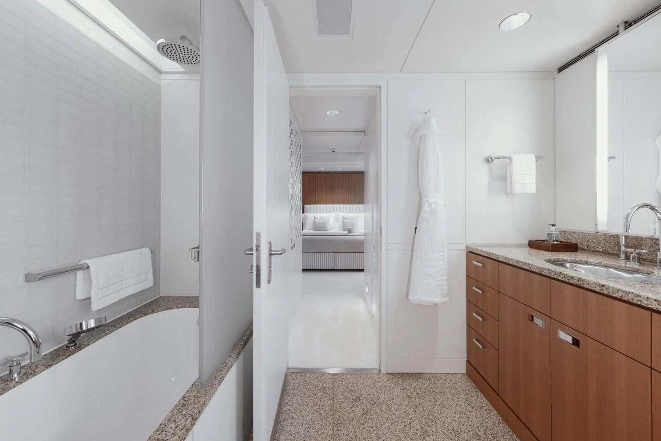 A luxurious bathroom with a bathtub, granite countertops, and ample storage space. aboard RONIN Yacht for Sale