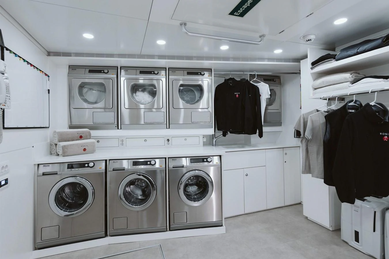 The yacht features a well-equipped laundry room with modern appliances and ample storage space. aboard RONIN Yacht for Sale
