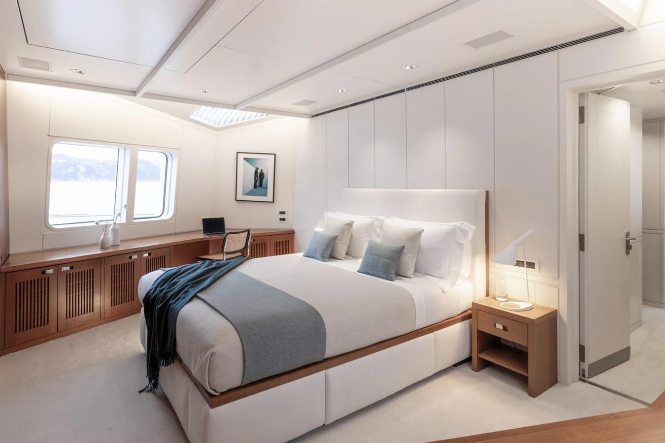 The master stateroom features a spacious bed, elegant decor, and ample natural light. aboard RONIN Yacht for Sale