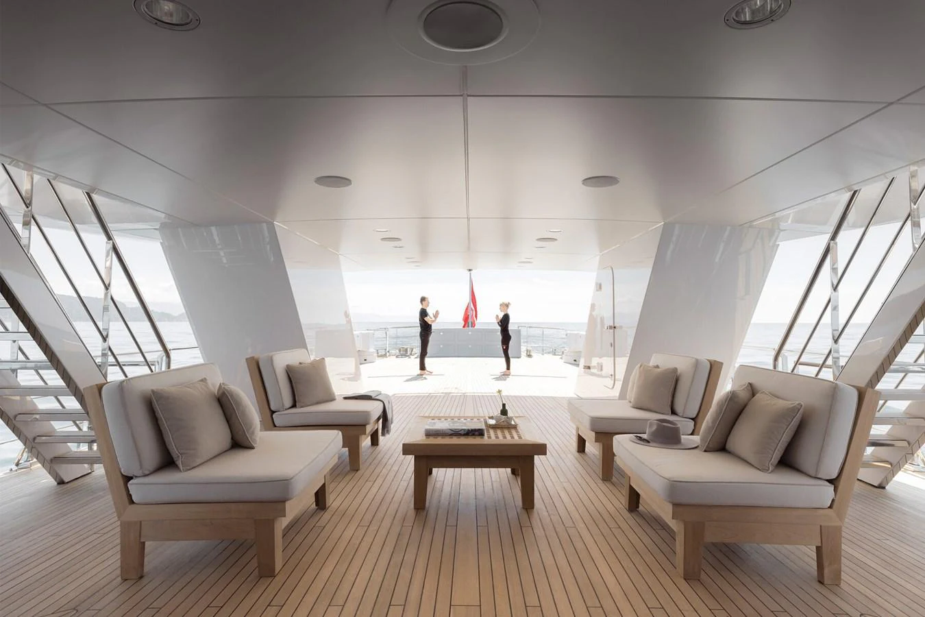 The aft deck features a spacious seating area with plush cushions and a central coffee table, perfect for relaxation and socializing. aboard RONIN Yacht for Sale