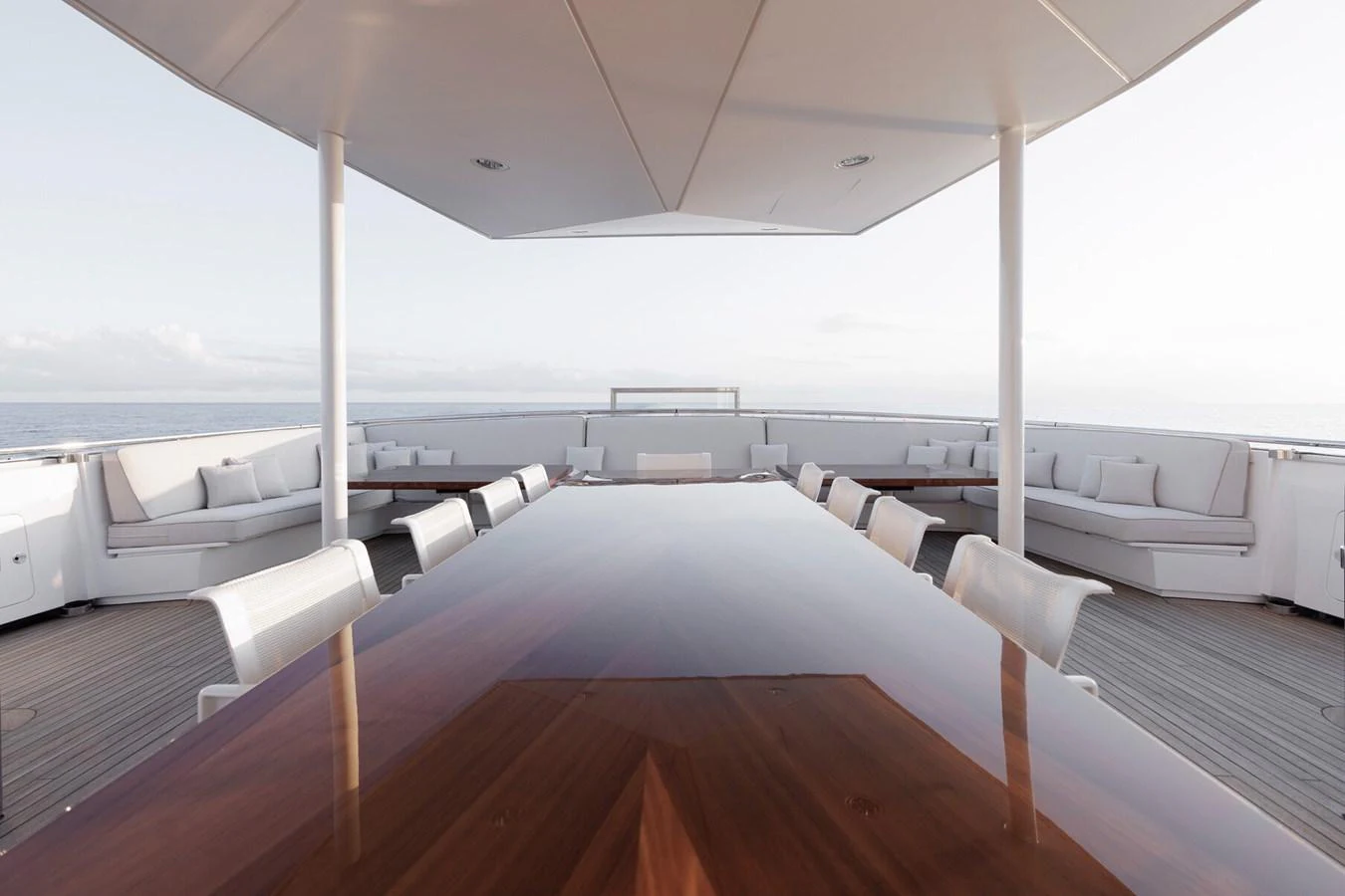 The aft deck features a spacious dining area with elegant seating and panoramic ocean views. aboard RONIN Yacht for Sale