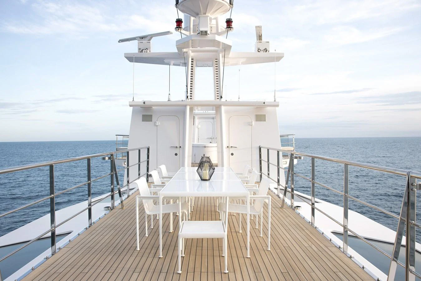 The aft deck features a stylish outdoor dining area with a stunning ocean view. aboard RONIN Yacht for Sale