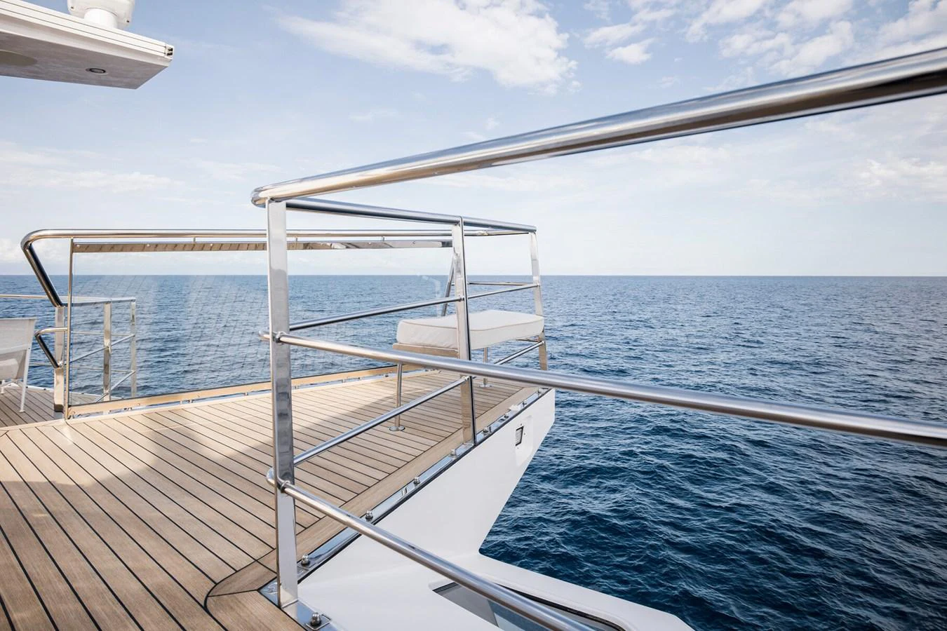 A sleek deck area with stainless steel railings offers stunning ocean views. aboard RONIN Yacht for Sale