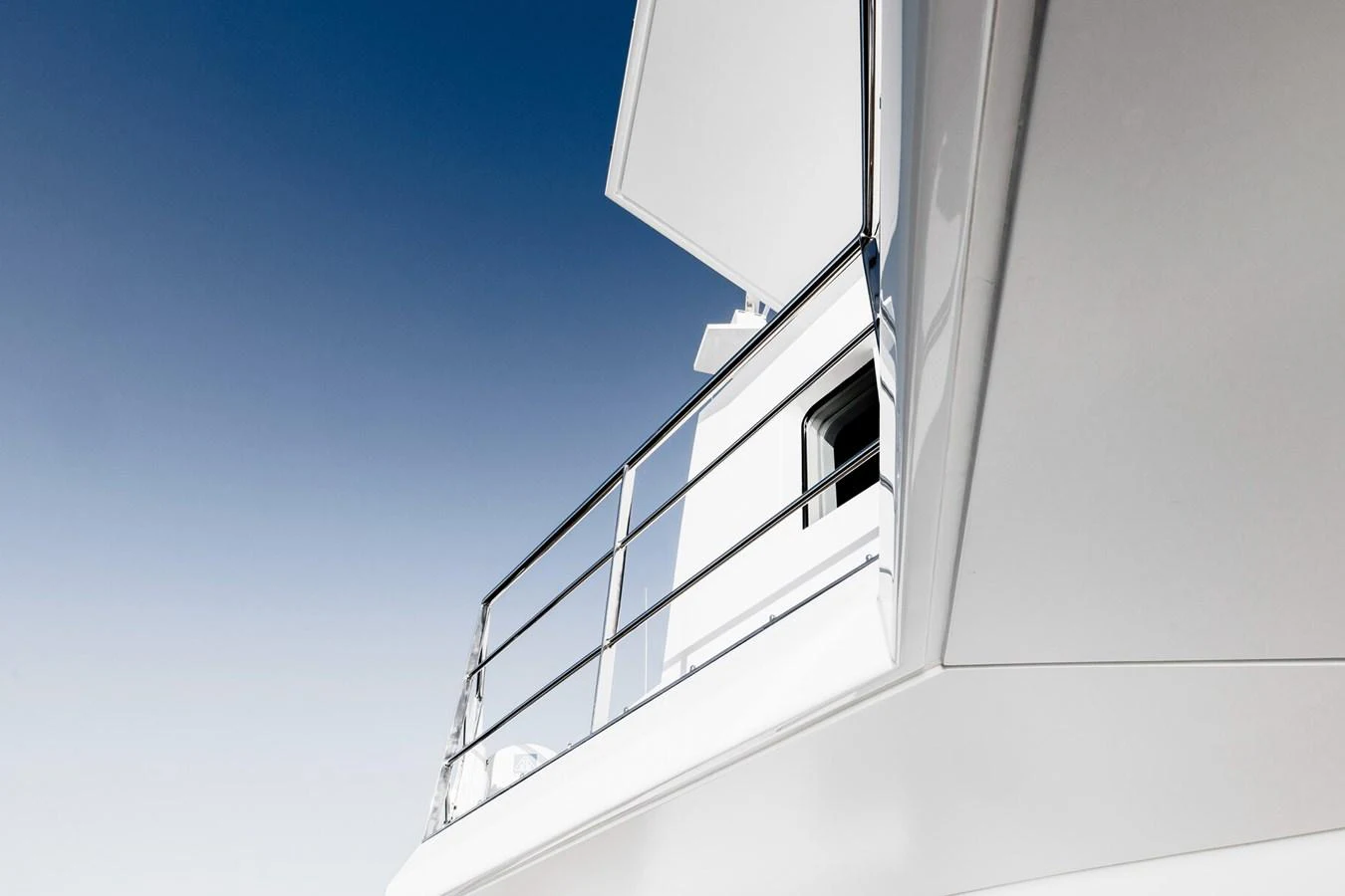 A close-up view of the yacht's sleek exterior with a focus on the railing and structure. aboard RONIN Yacht for Sale