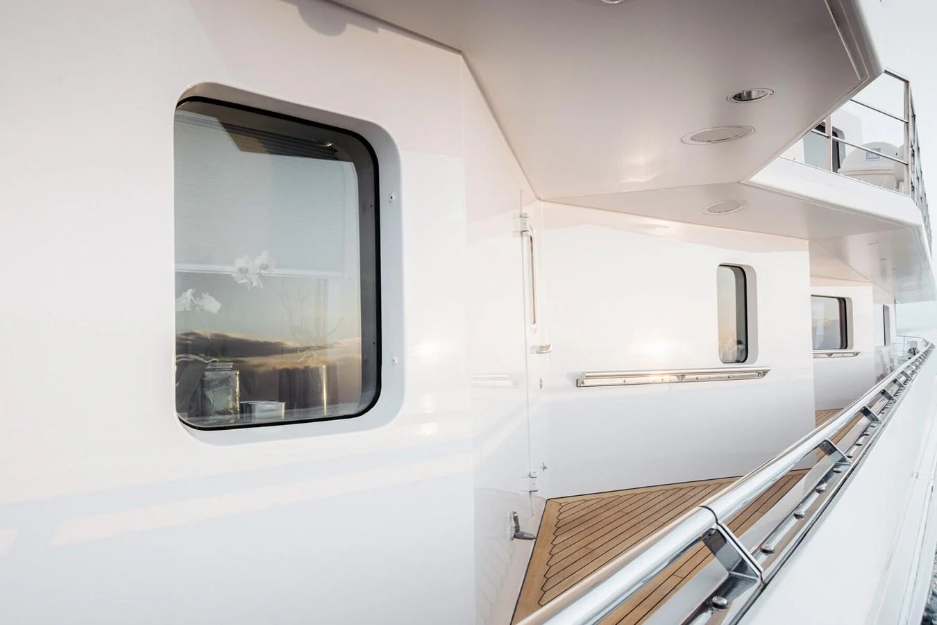 The sleek exterior walkway of the yacht showcases modern design and pristine finishes. aboard RONIN Yacht for Sale