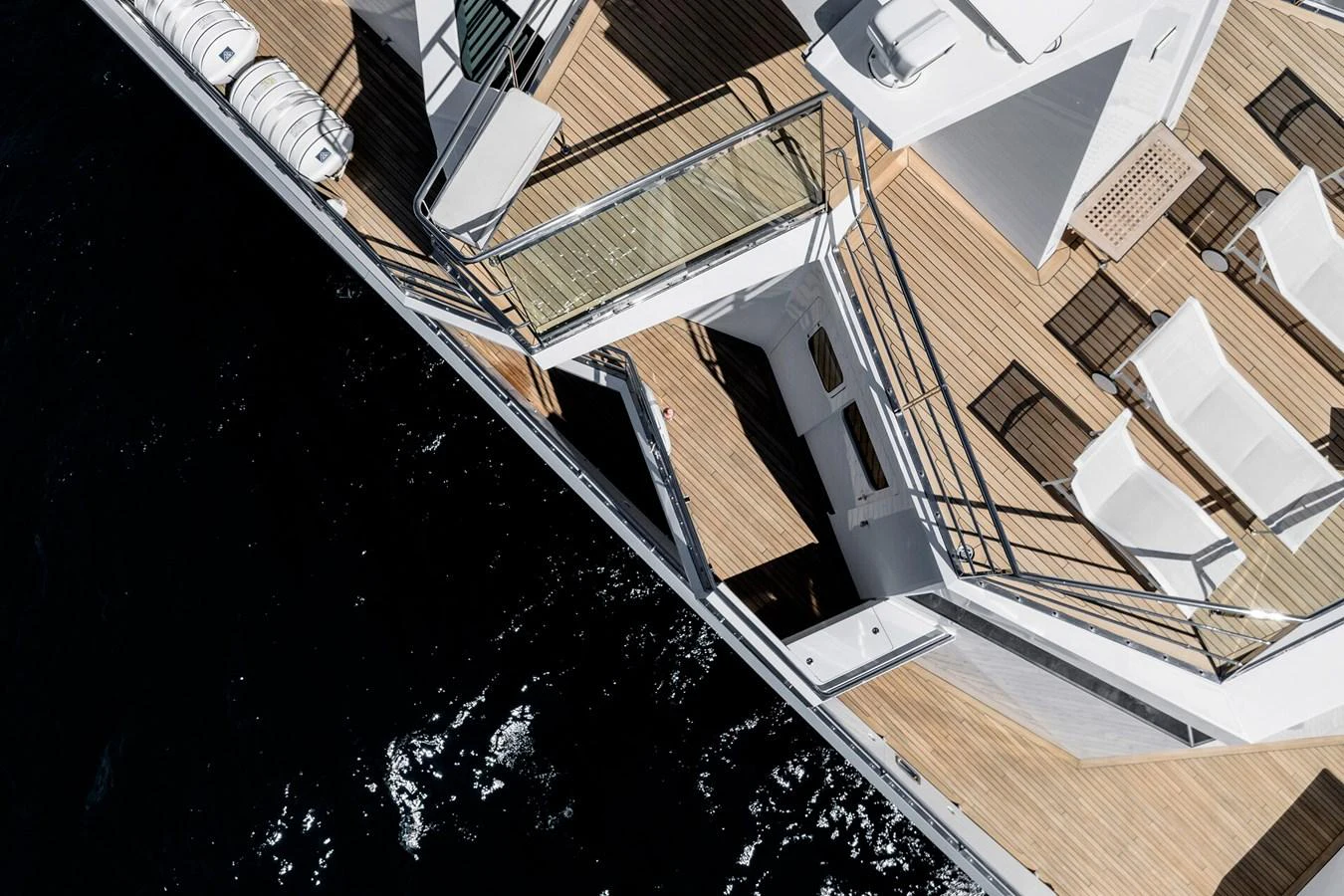 The yacht's aft deck features a spacious layout with elegant sun loungers and a sleek design. aboard RONIN Yacht for Sale