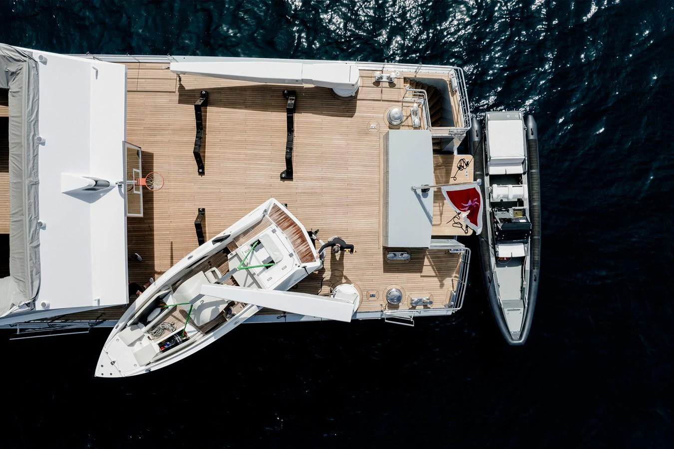 The aft deck of the yacht features a tender and a small boat, showcasing its versatility and readiness for adventure. aboard RONIN Yacht for Sale